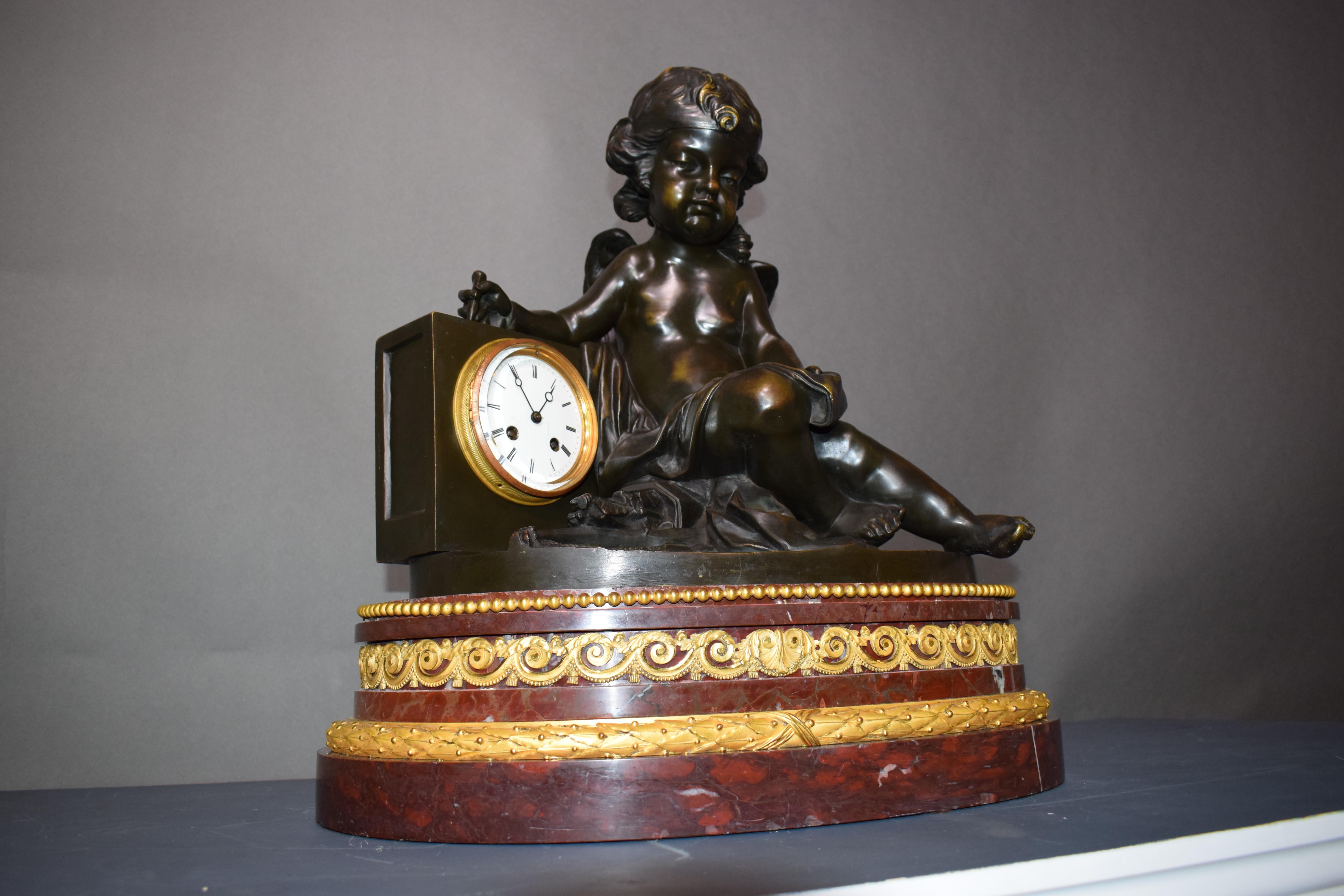 A magnificent bronze clock depicting a resting Cupid For Sale 9