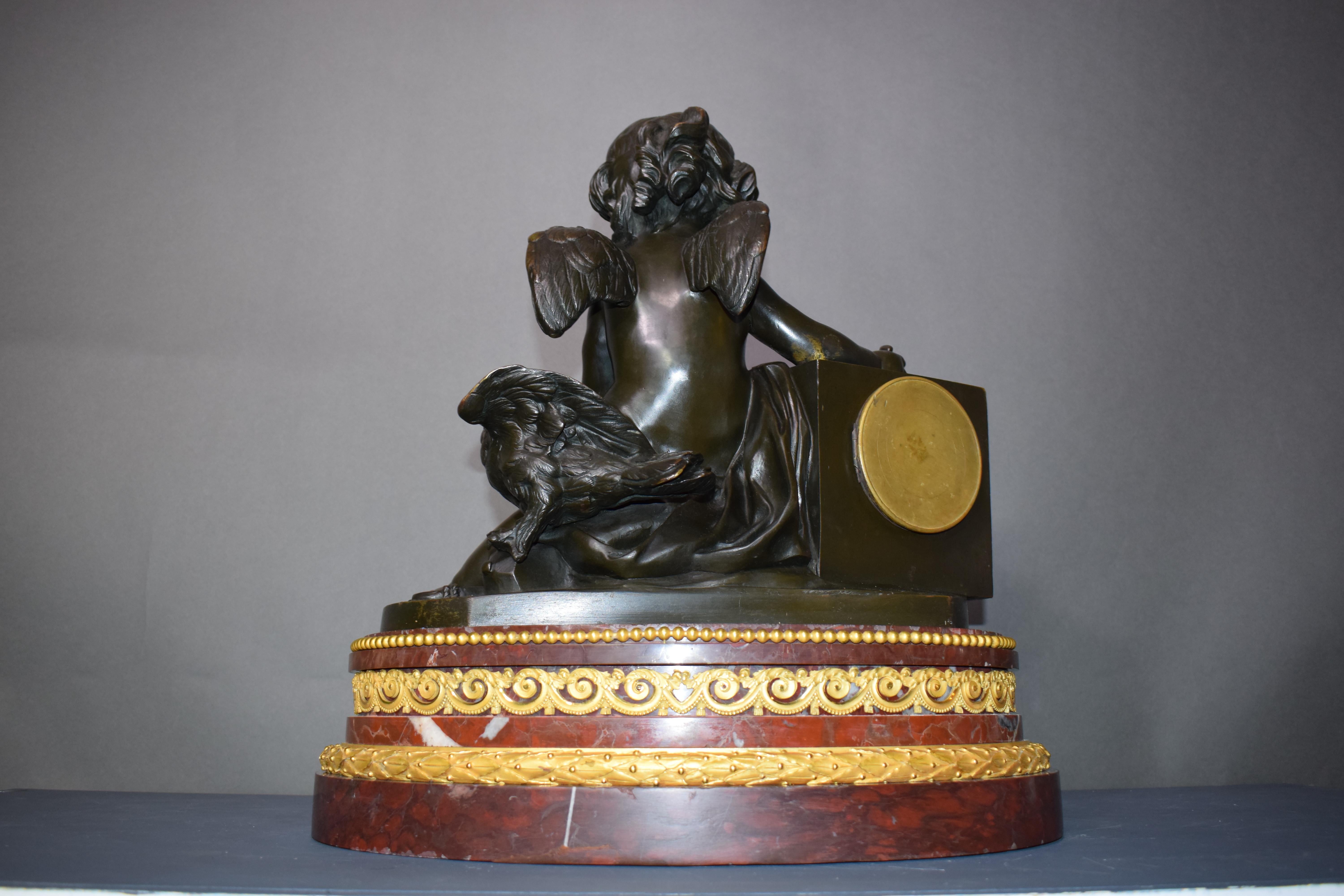 Louis XVI A magnificent bronze clock depicting a resting Cupid For Sale