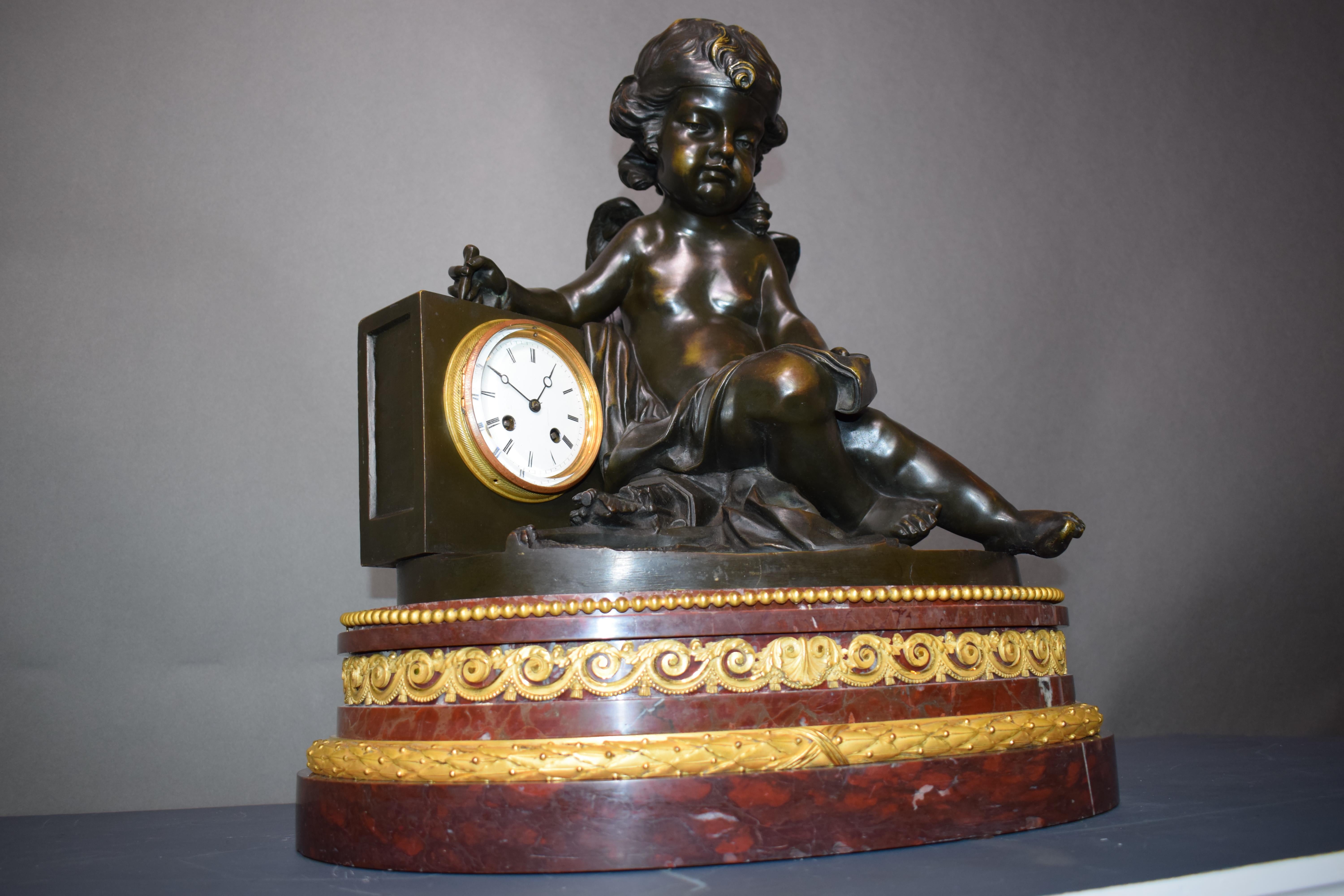 French A magnificent bronze clock depicting a resting Cupid For Sale