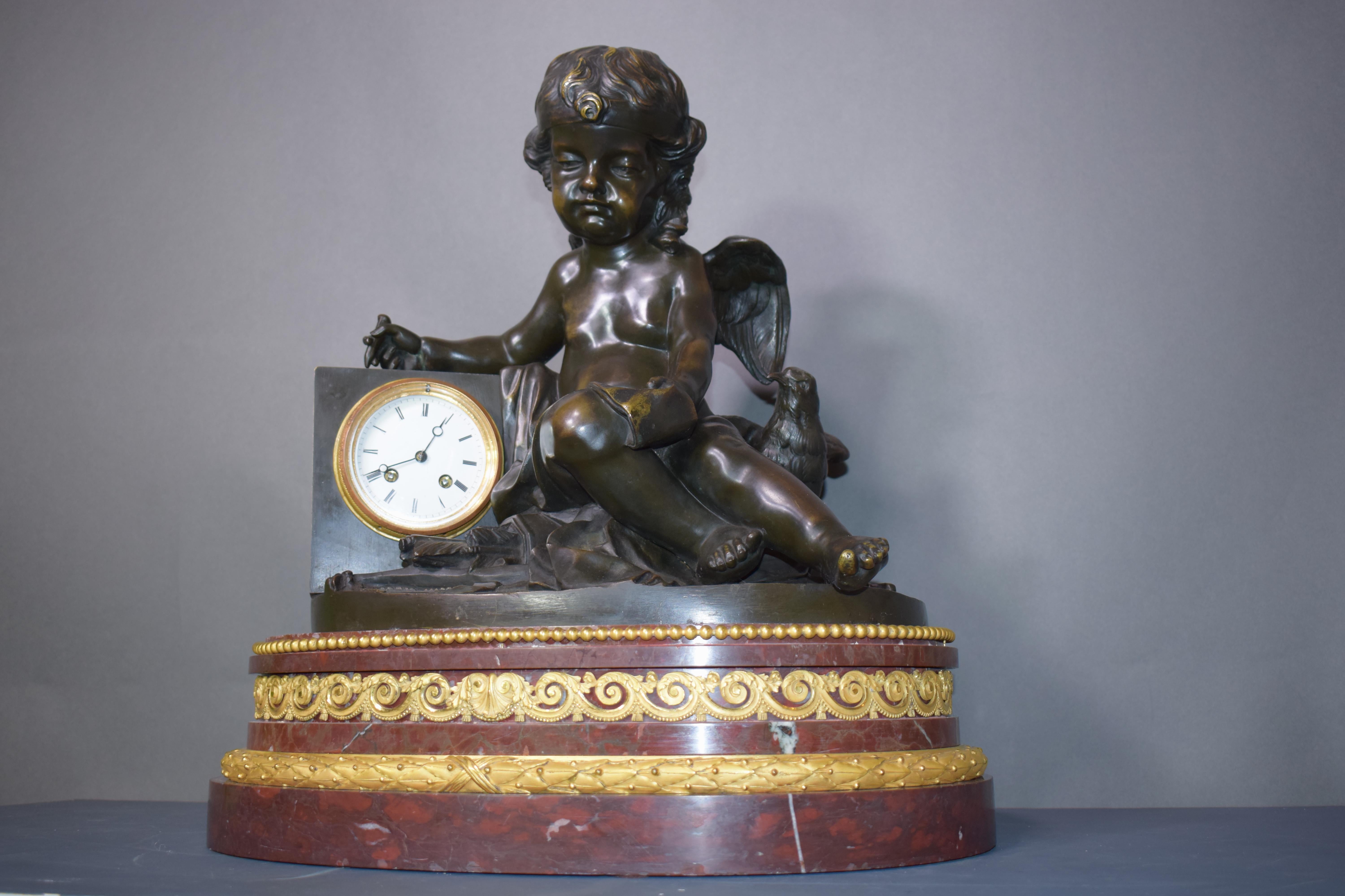 Gilt A magnificent bronze clock depicting a resting Cupid For Sale