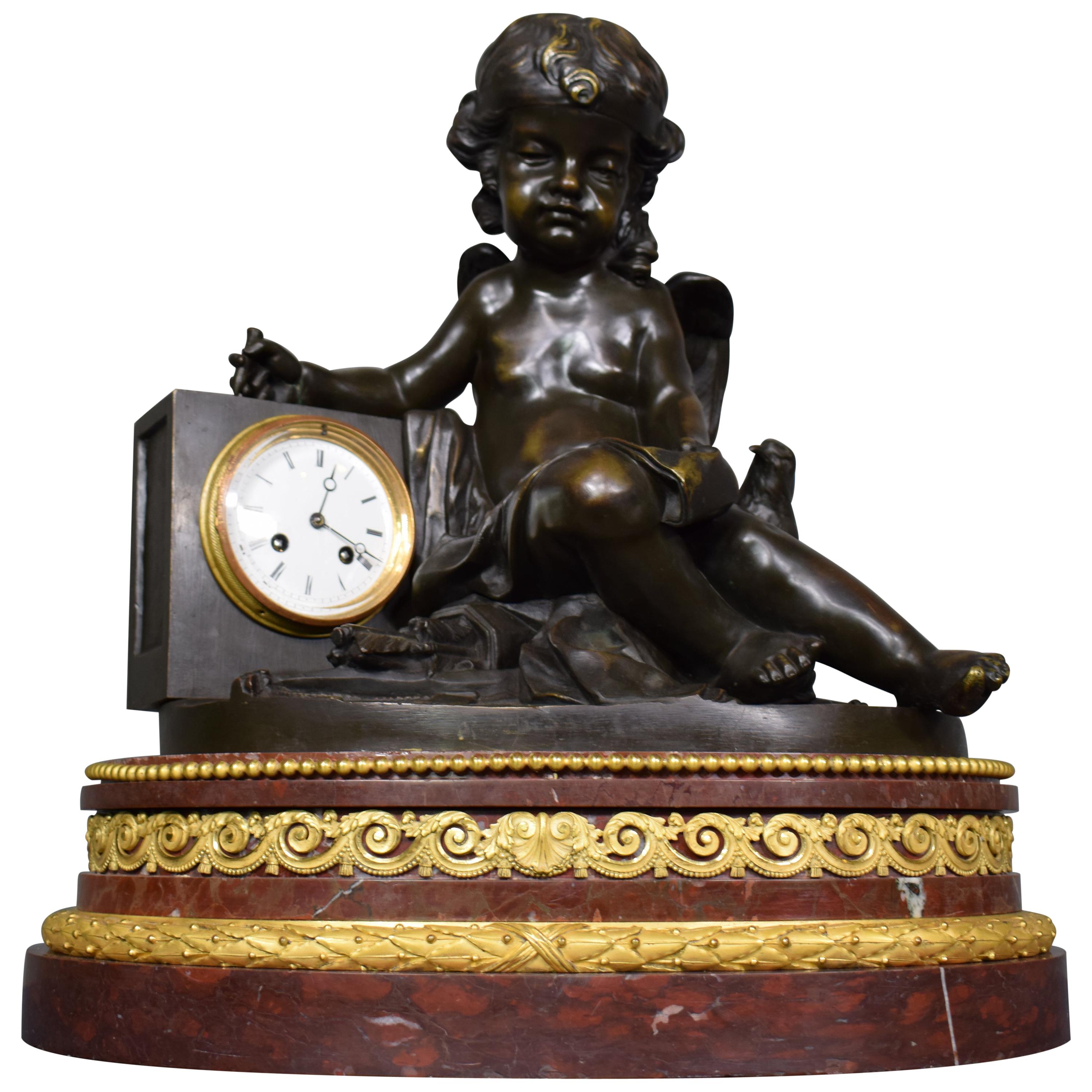 A magnificent bronze clock depicting a resting Cupid For Sale