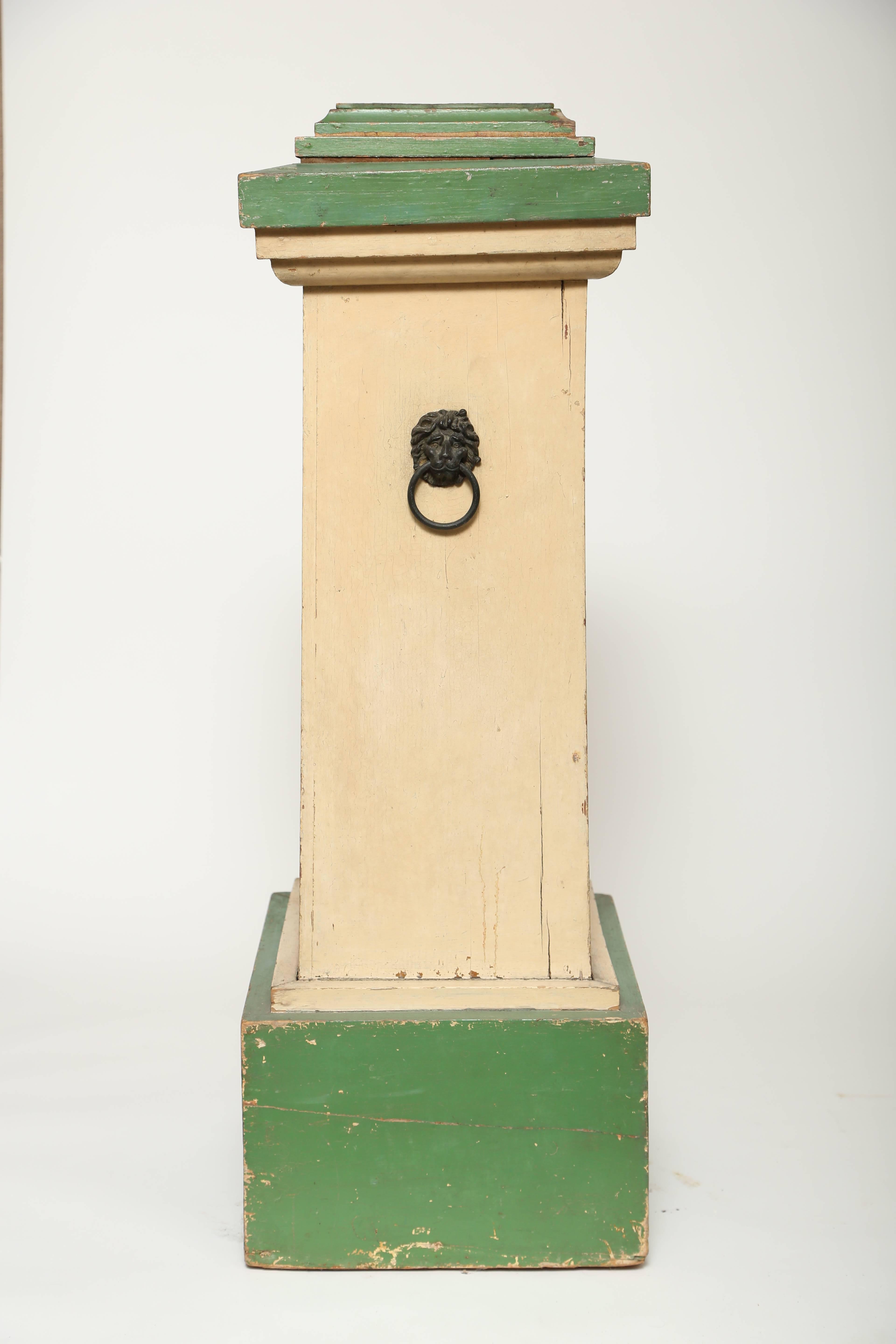  Hand-painted wood pedestal with lion's head handles from an English conservatory. Original green and cream painted decoration. Wonderful character and patina.  Initially created to display a prize plant, however, it would look equally as smart with