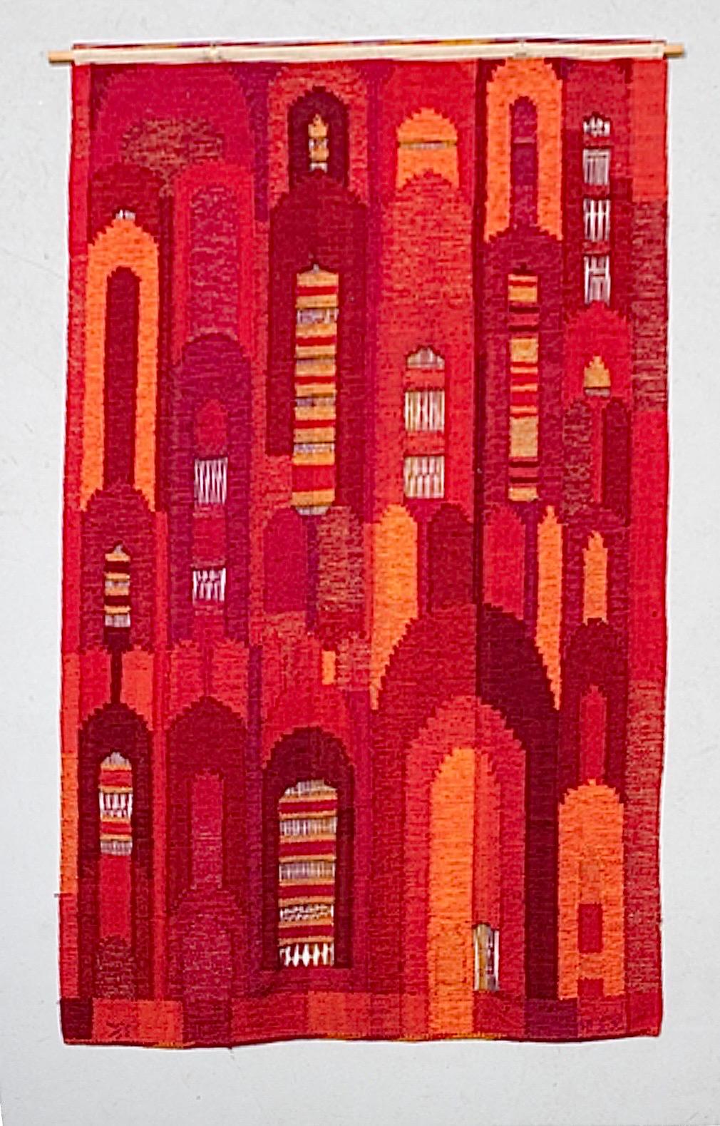 This is the Swedish considerable large tapestry by Irma Kronlund, handwoven for Kronoberg Läns Hemslöjd, measuring majestic 90x56 in (229x142 cm).

It comes in a beautifully color range in red and orange and this wonderful motif depicting a group