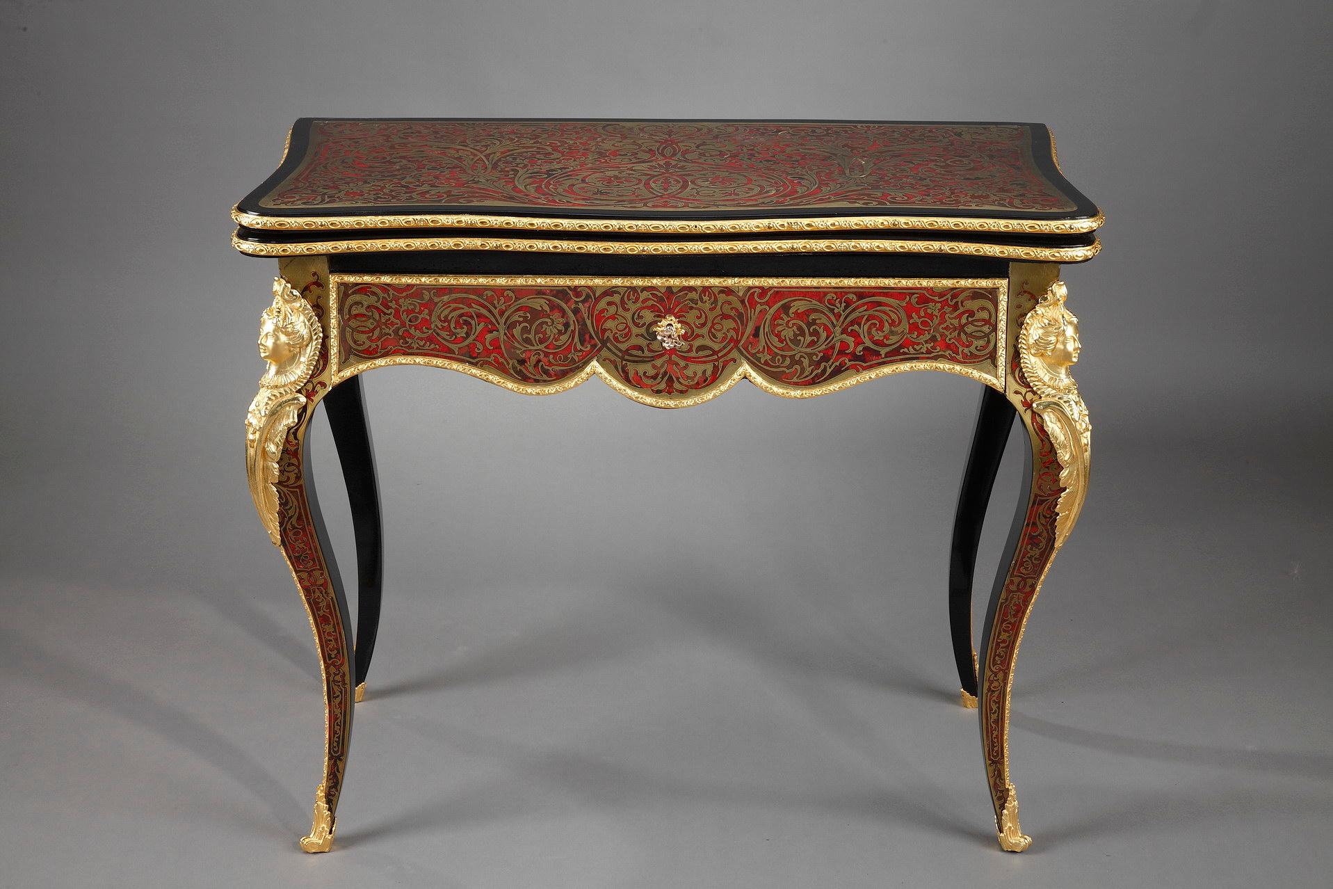 Console in Boulle marquetry with brass background with scrolls, arabesques and flowers, convertible into a game table. The console is richly decorated with gilded bronzes. The top is surrounded by a finely chiseled baguette and rests on four arched