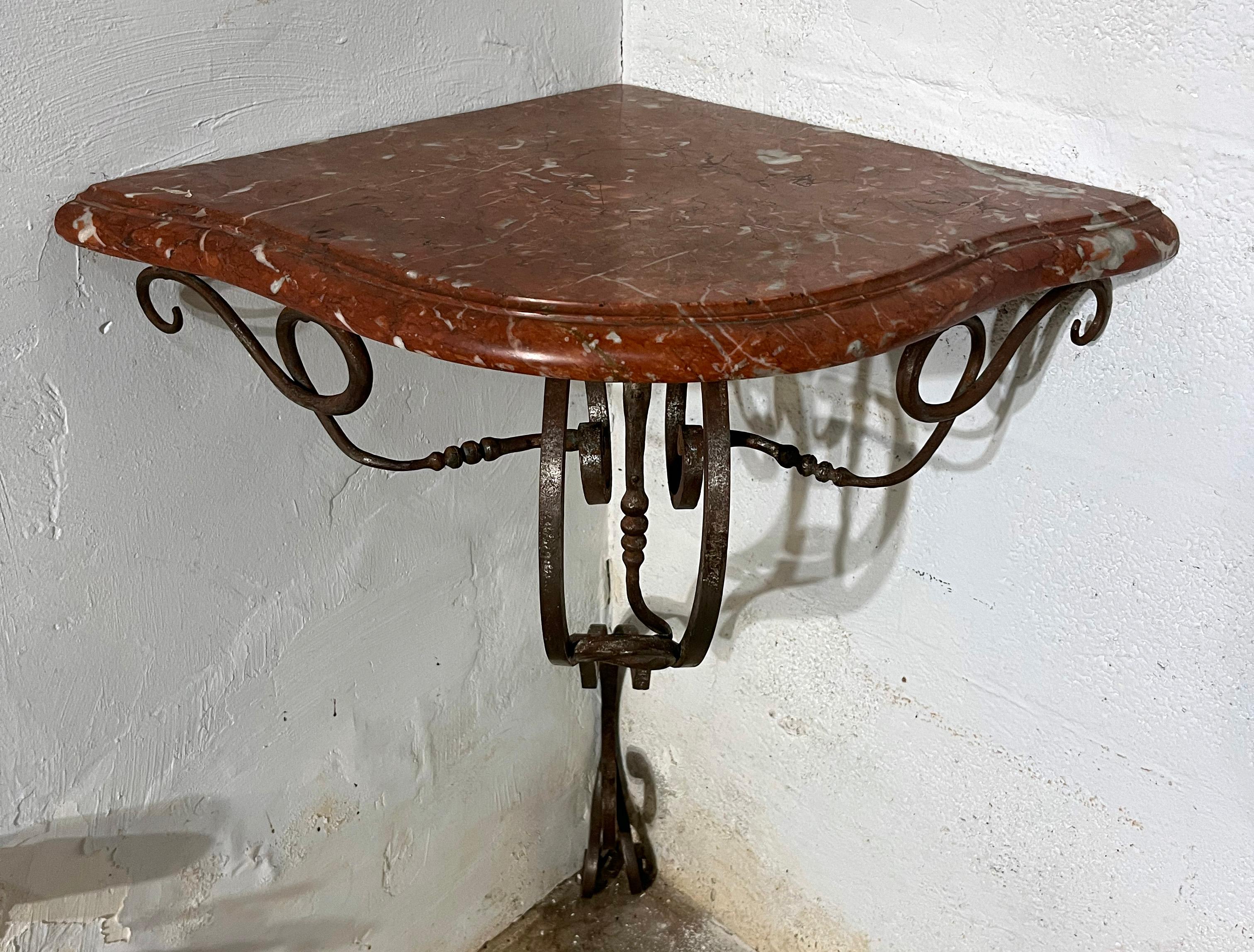 Refined angle console Table in wrought iron with original patina and griotte marble Top .
