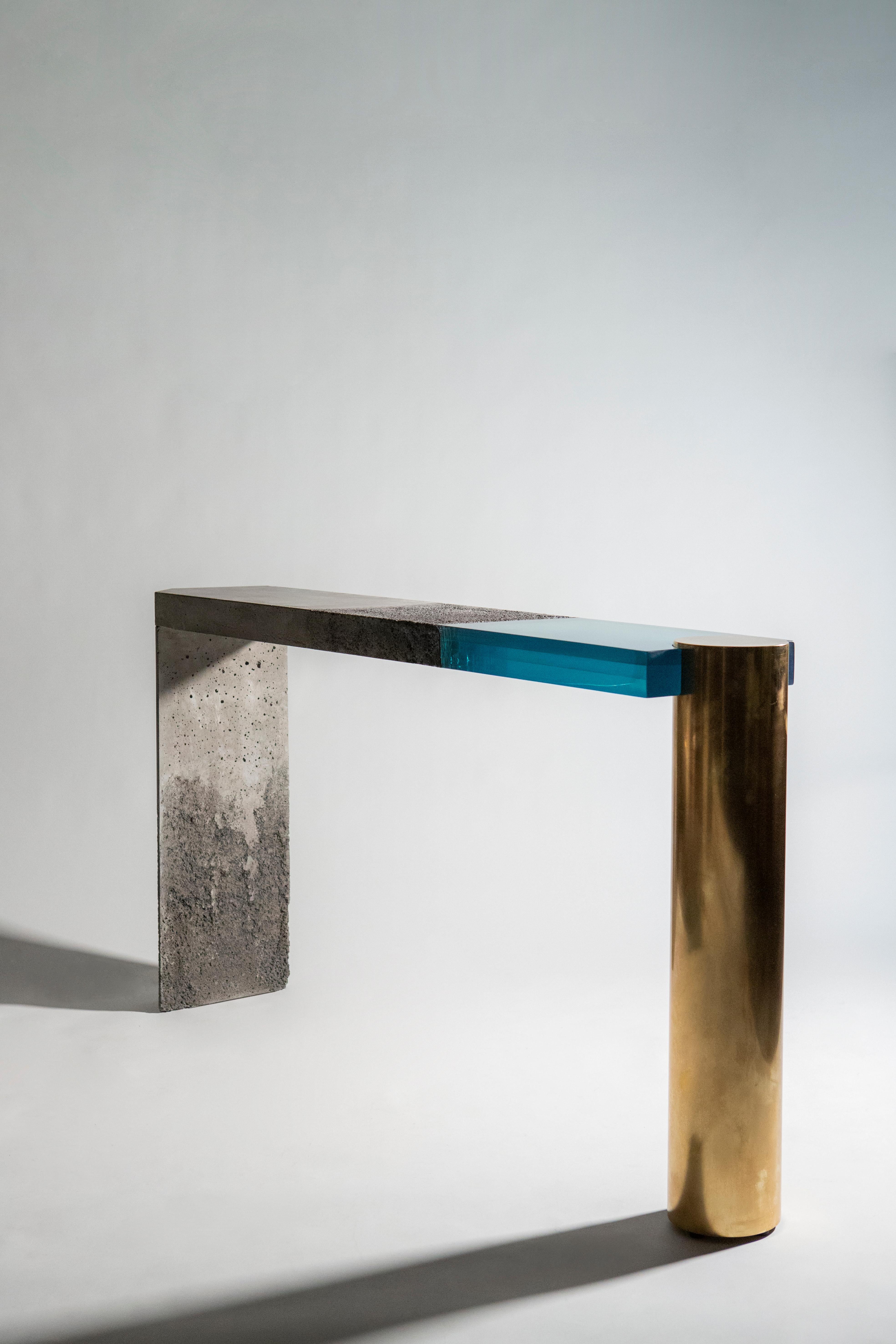 Dialoghi Mimetici Collection by Draga&Aurel:

Console in concrete with details obtained through a technique involving the corrosion of sea salt. Part of the top is made in cast resin.
Hand finished brass leg. Handcrafted in our Atelier in Como.
Each