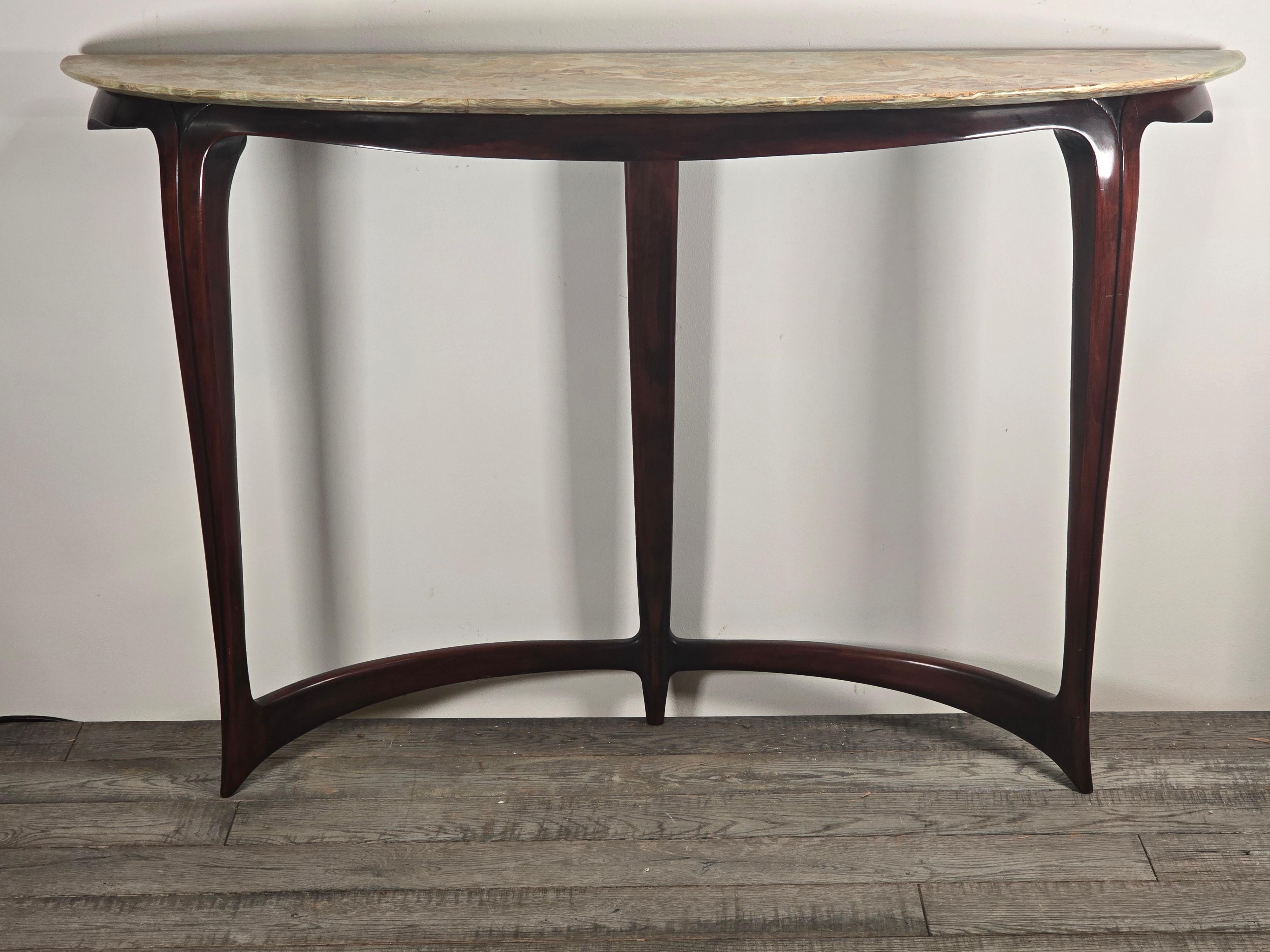 Console attributed to italian Architect and designer Carlo Enrico Rava.  Carved and polished mahogany with an onyx top that has a knife edge going around the console.   This piece dates to the early 1940s. 

Rava was a member of Gruppo 7 which was a