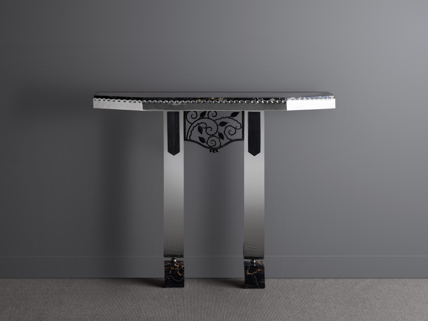 Chromed metal console, the upper part supporting a portor marble top with an openwork wrought iron panel mounted directly below. The feet rest on two marble blocks. Signed “L Katona.”

OUR REFERENCE N10015