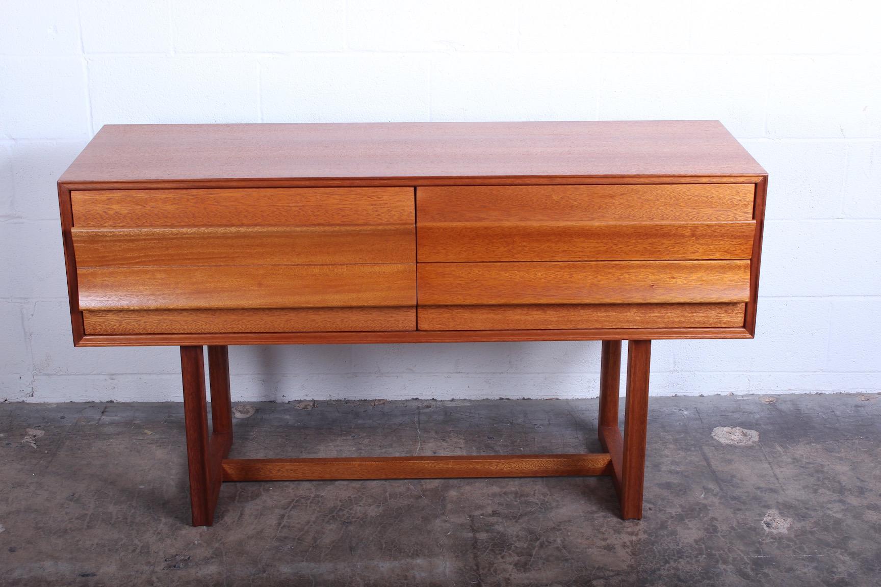 A bleached mahogany console table designed by Paul Laszlo for Brown Saltman.