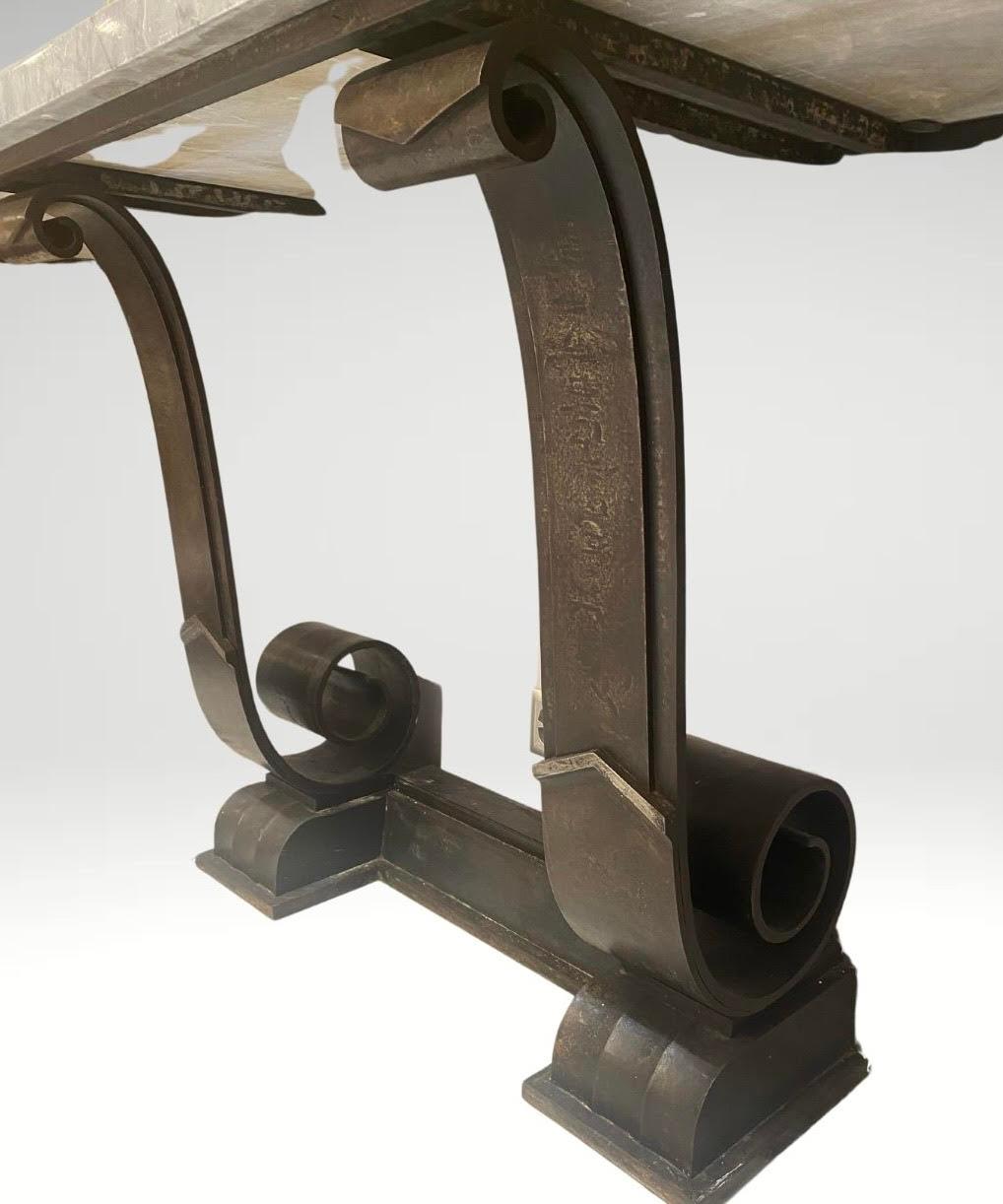 This article showcases a remarkable console table designed by Raymond Subes, crafted in 1930. Renowned for his expertise in wrought iron, Subes combined elegance with functionality in this piece, which features intricate detailing and a