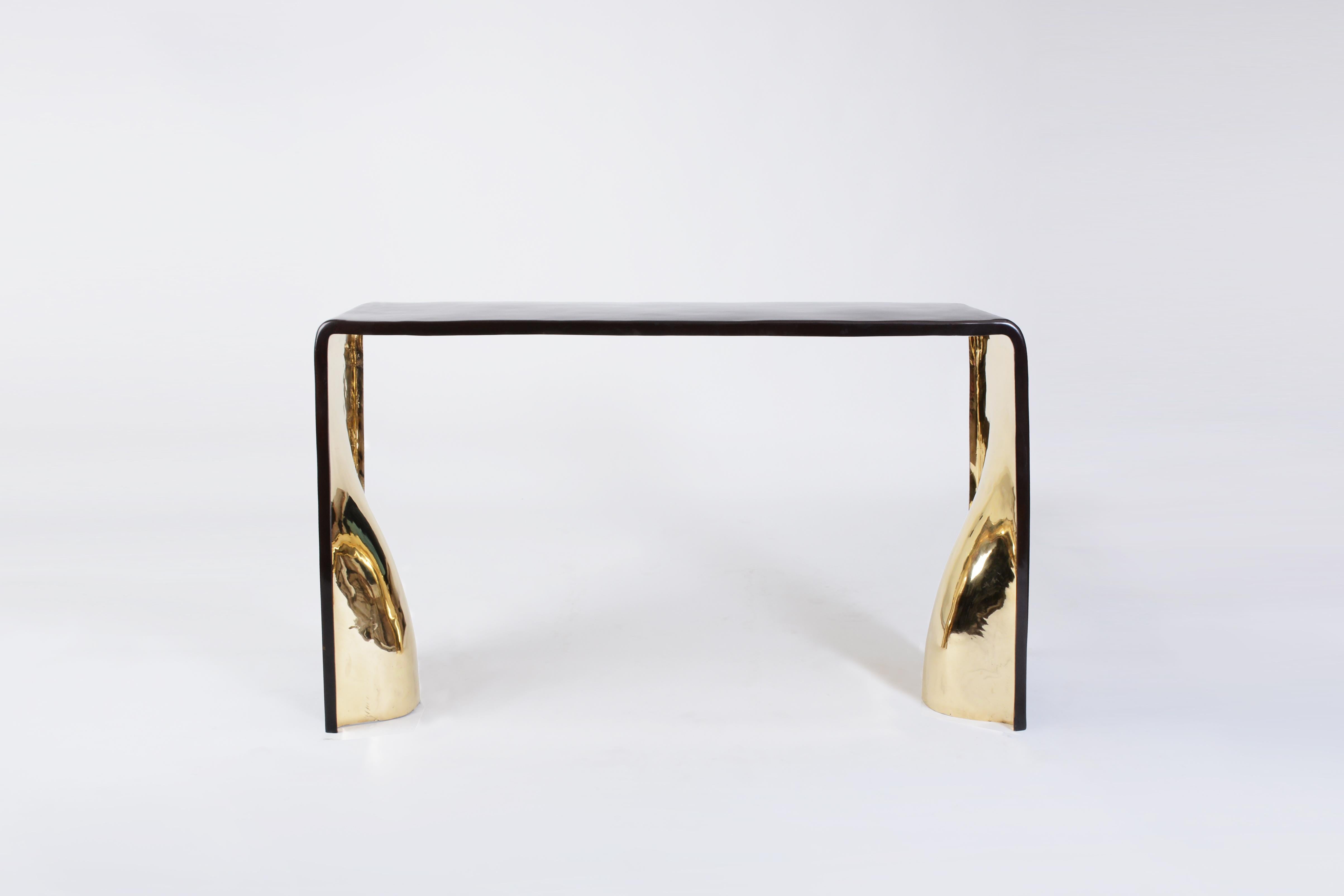 Khetan Console in Dark Bronze with Polished Gold Bronze Interior by Elan Atelier

The Khetan console is a bronze sculptural piece inspired by contemporary artists such as Constantin Brancusi and Isamu Noguchi. Cast using the lost wax method, the