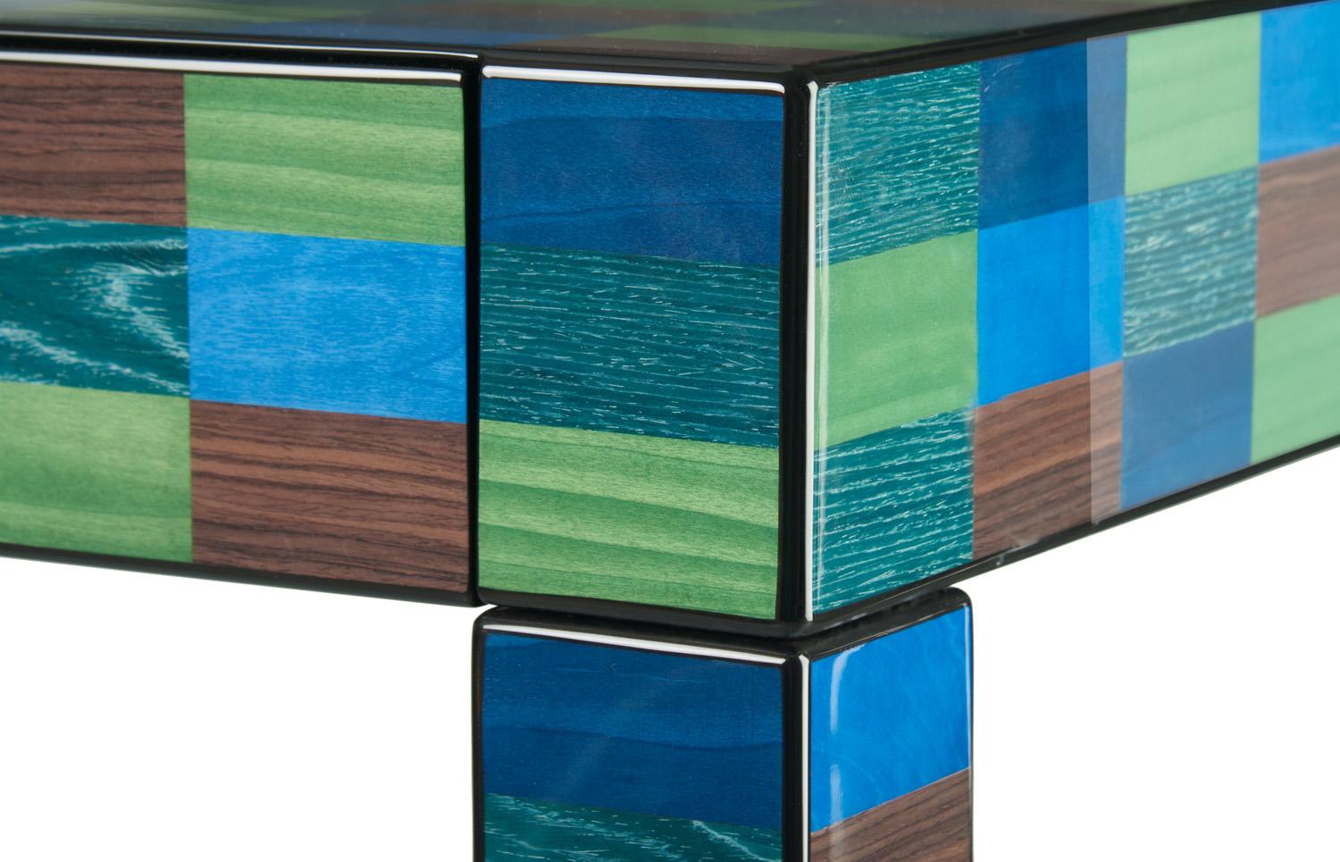 A striking sculptural objet d'art that doubles as a console, this stunning piece will add color and cheer to any modern or eclectic entryway. A bold design of strong geometric value, it is handcrafted of wood entirely veneered with an inlay of