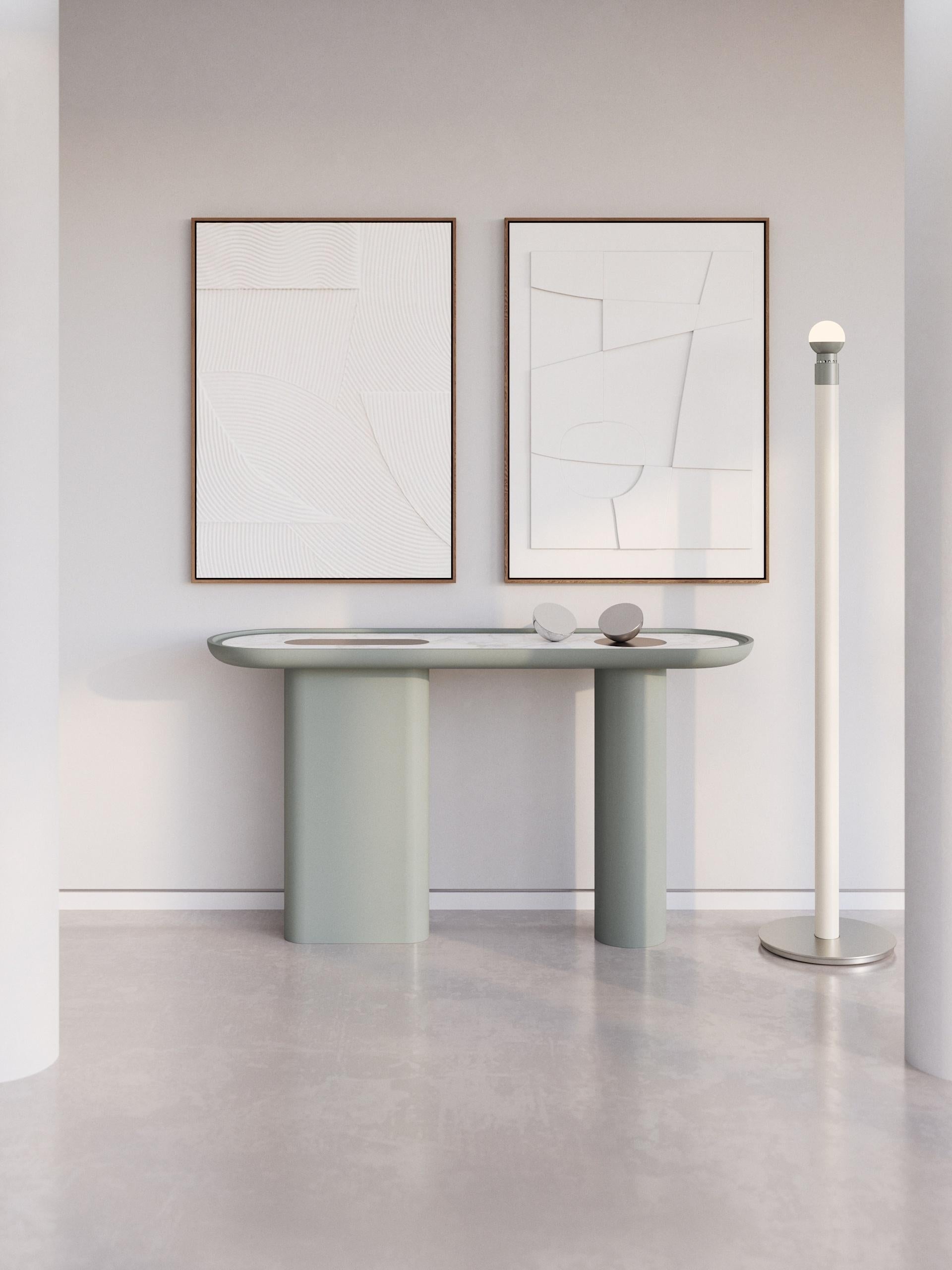 Part of the Creta series, this console is fully lacquered in a matte H/Halcyon Green finish with one round and one oval leg. The shaped top is enriched with a White Arabescato marble insert and some satin inox details.