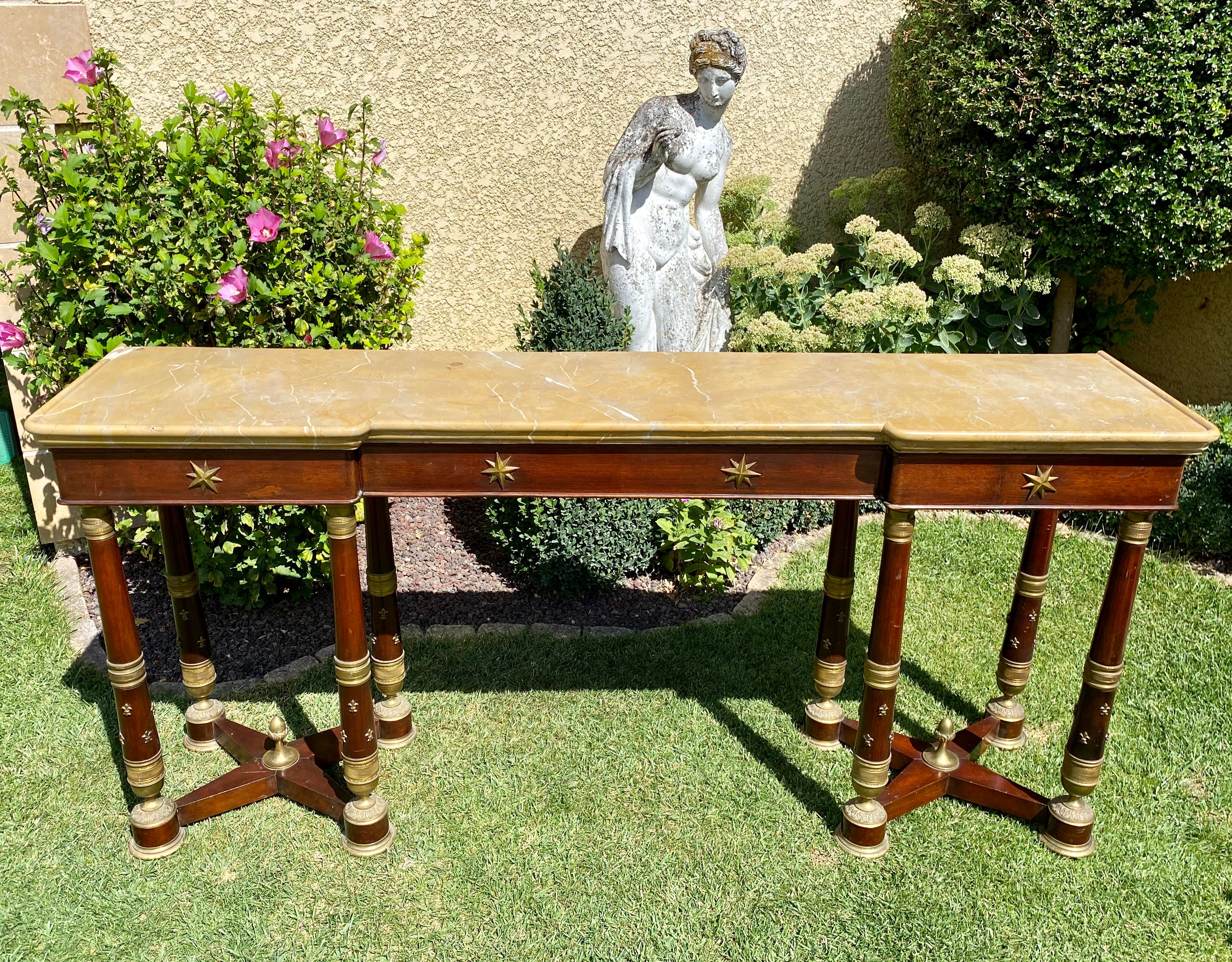 Rare and superb Empire style mahogany console table decorated with gilded bronzes. It is topped with an original Siena marble in good condition. This console is large in size which is unusual and has three drawers on the front. 
French work of the