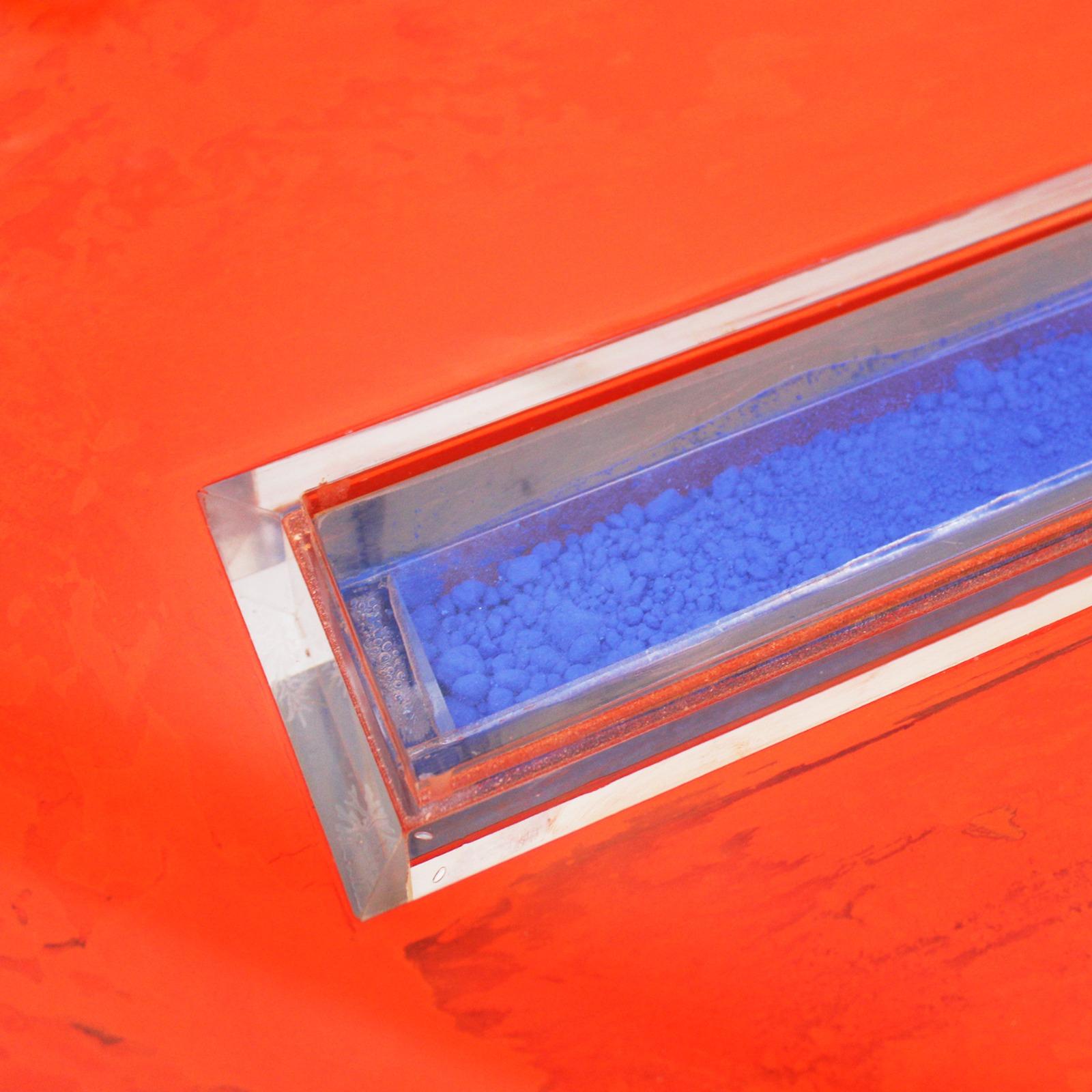 Console composed of three pieces made of methacrylate with colored pigments inside.

