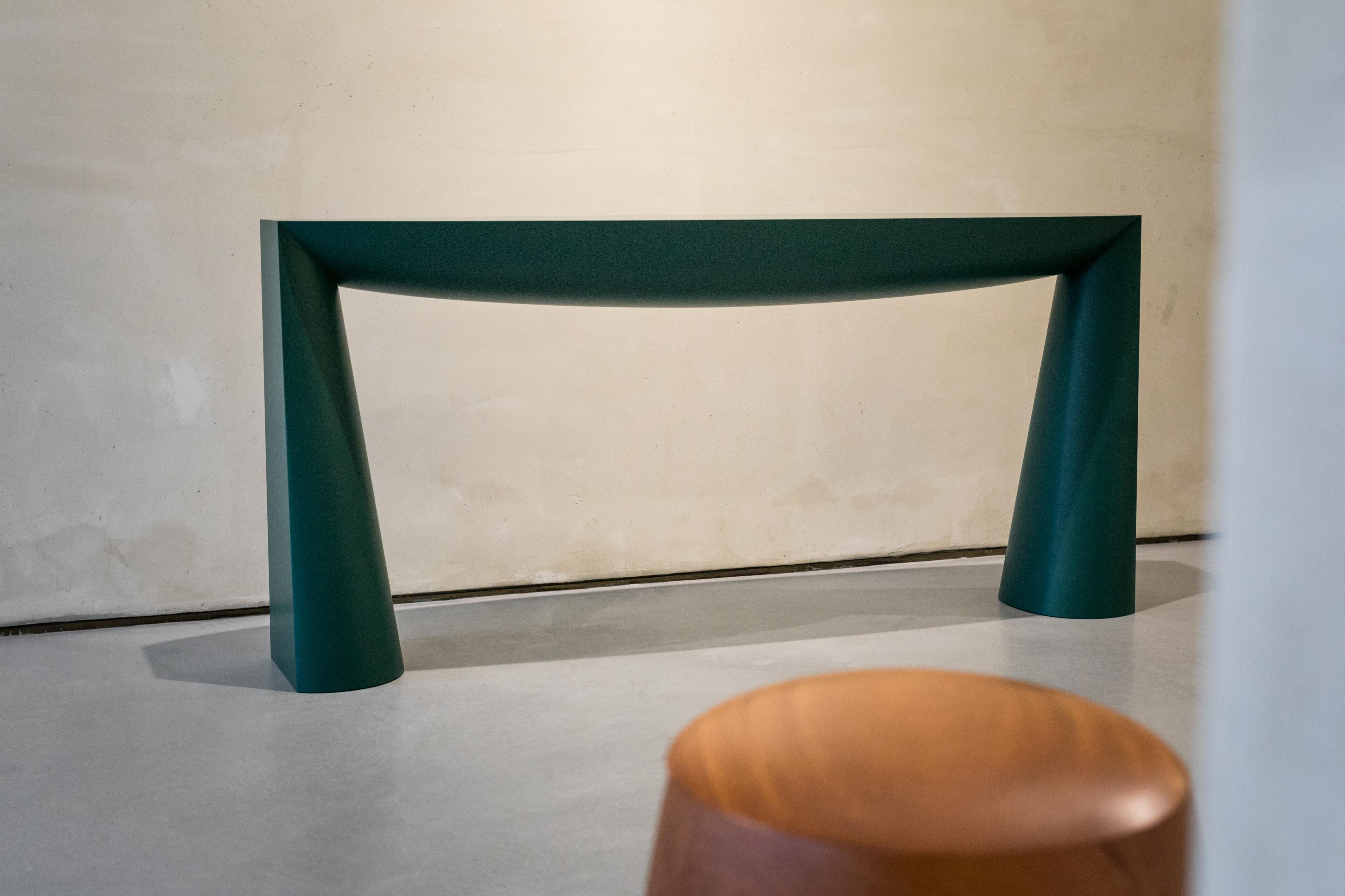Limited Green Edition of 8

Edition n°1 available

First exhibited at the Galerie Vidid in Rotterdam, the Console table of Aldo Bakker depicts the simplest design concept of a table: two legs and a surface. The legs are an elongation of the line