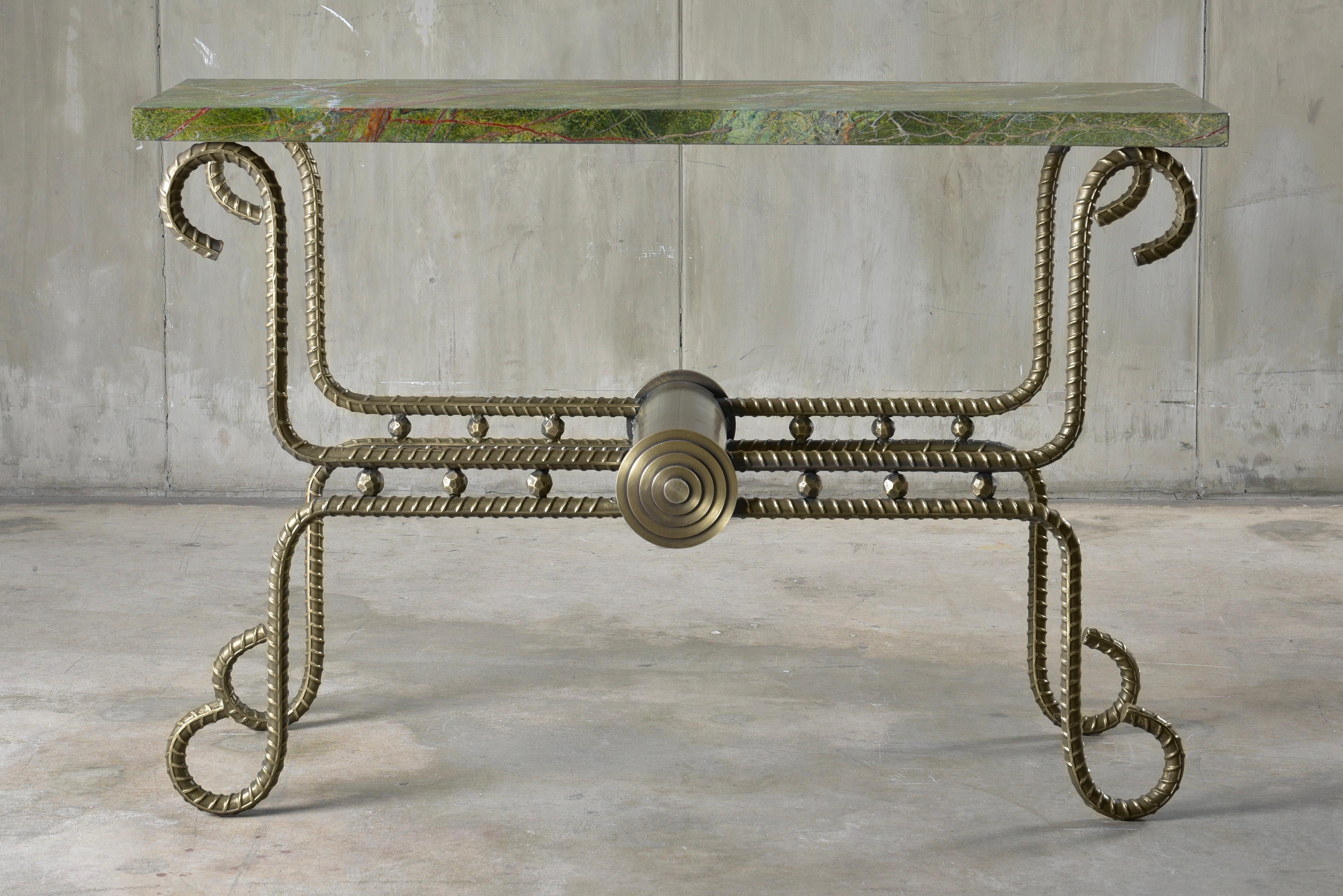 The Akhenaten Console Table is part of the Rebar series created by artist Troy Smith. 

Rebar is the steel used in the forming of concrete to give it strength. The rebar is heated with acetylene torches and red-hot forges. Skillfully sculpted by