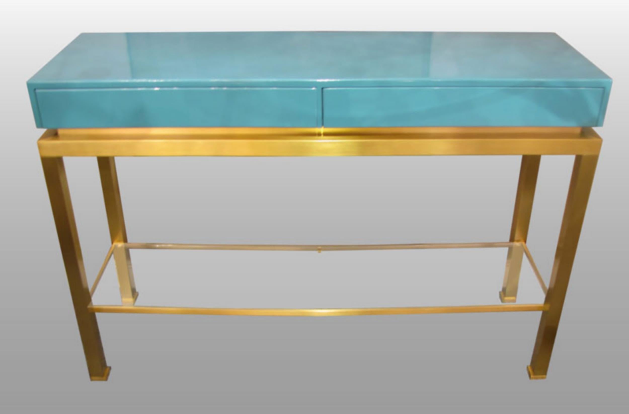 Console in brushed brass and turquoise-blue lacquer, two-drawer pedestal front, lower shelf in clear glass.
Guy Lefevre for Maison Jansen, circa 1970.
Cabinet and drawer interiors in mat varnished Sapelli mahogany.

Biography

Guy Lefèvre is a