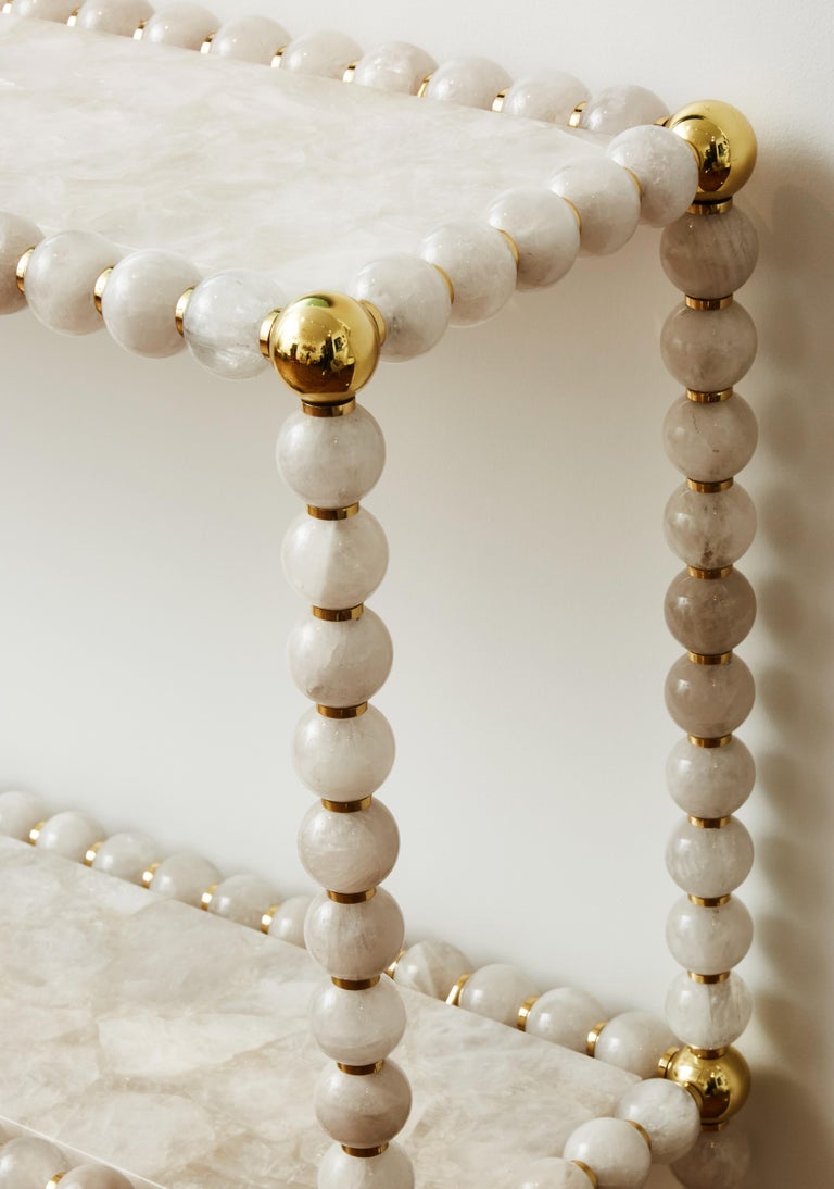 Brass console with rock crystal balls and tops. Creation by Studio Glustin.