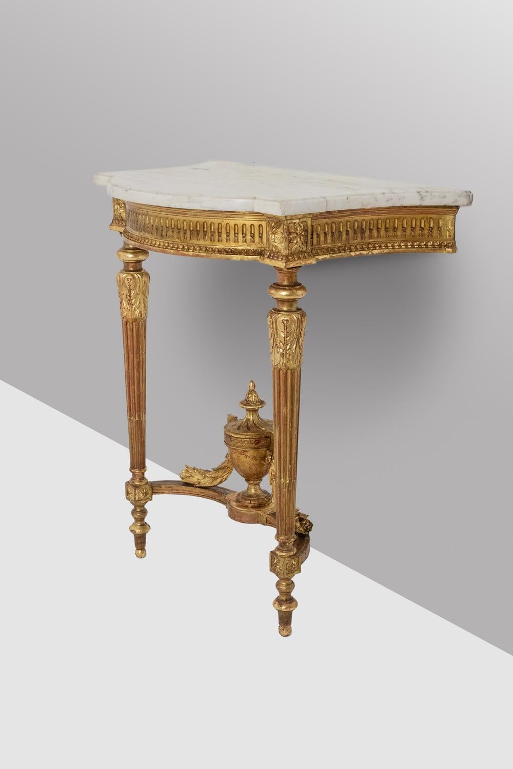 Louis XVI style console, the carved and gilded wooden base in a top shape, tapered and fluted, decorated with acanthus leaves in the upper part, joined by a spacer bar decorated with a fire pot in the central part and cornucopias decorated with