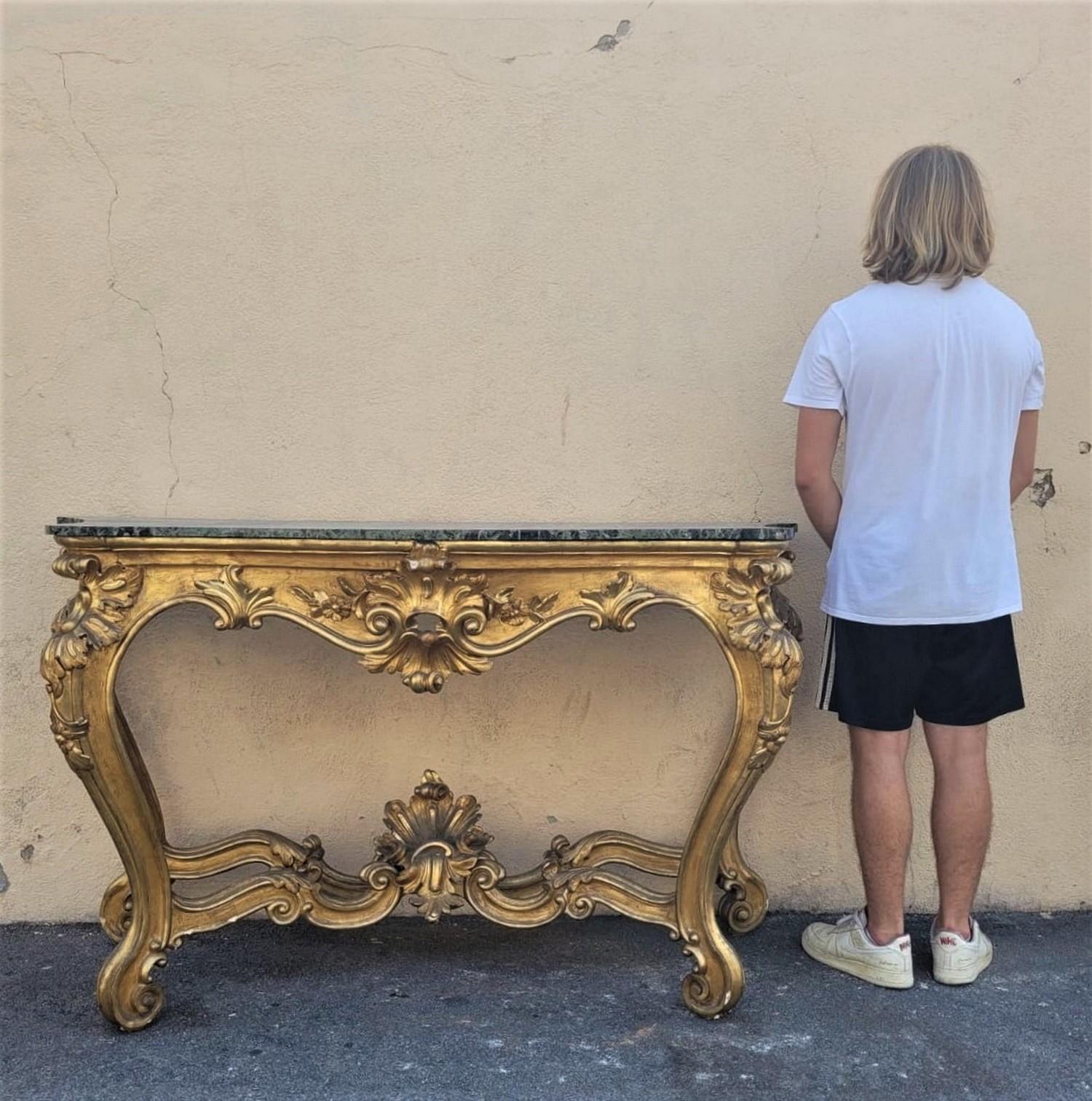 Beautiful console in gilded and carved wood, Louis XV style, surmounted by a green marble top

Good condition, wear to the gilding, restored marble (it was broken in 2)

Period 19th century

Measures: H95cm
163.5 x
