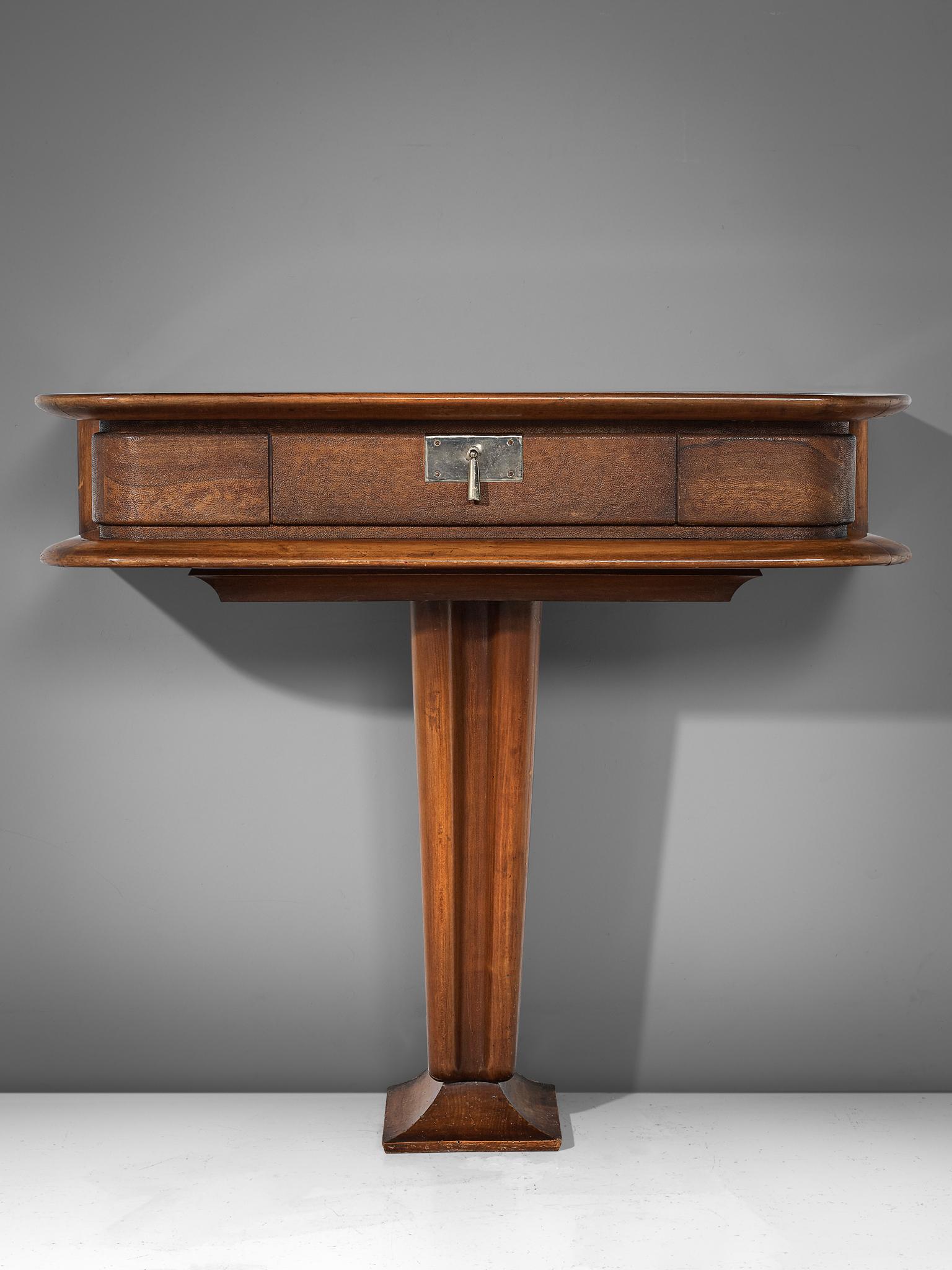 Vittorio Valabrega, console, walnut and leather, Italy, 1940s

This console by the Italian artist and designer Vittorio Valabrega is sculptural and elegant. The walnut storage case rests on a pedestal foot and the piece is inlayed with leather at