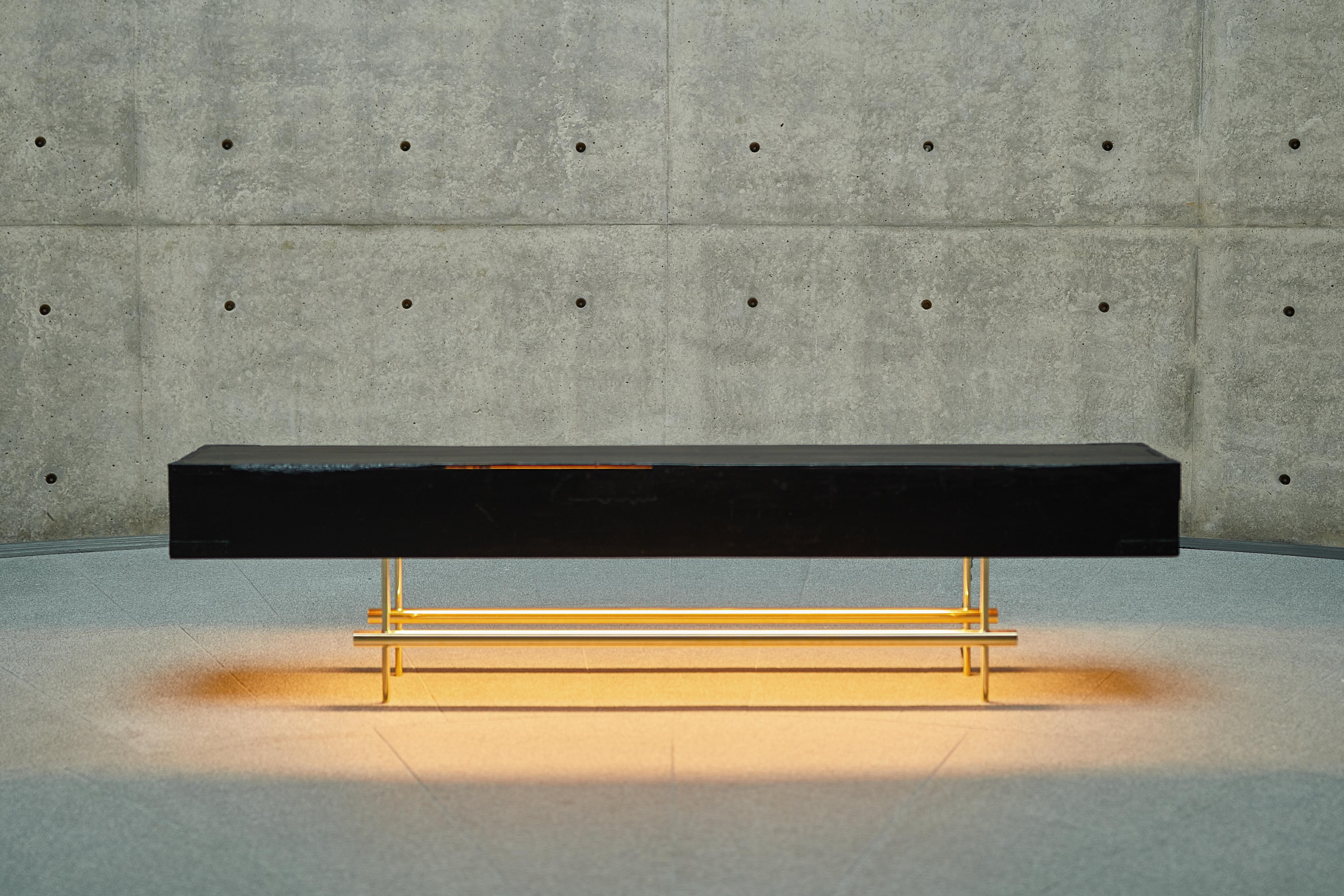 Console light table designed by Ryosuke Harashima.
Name: How deep the dark.
Collection: Stillife
A low table by morphing a wooden box lid that stores two Japanese gold folding screens. The lights are emphasis the attractiveness of black, which