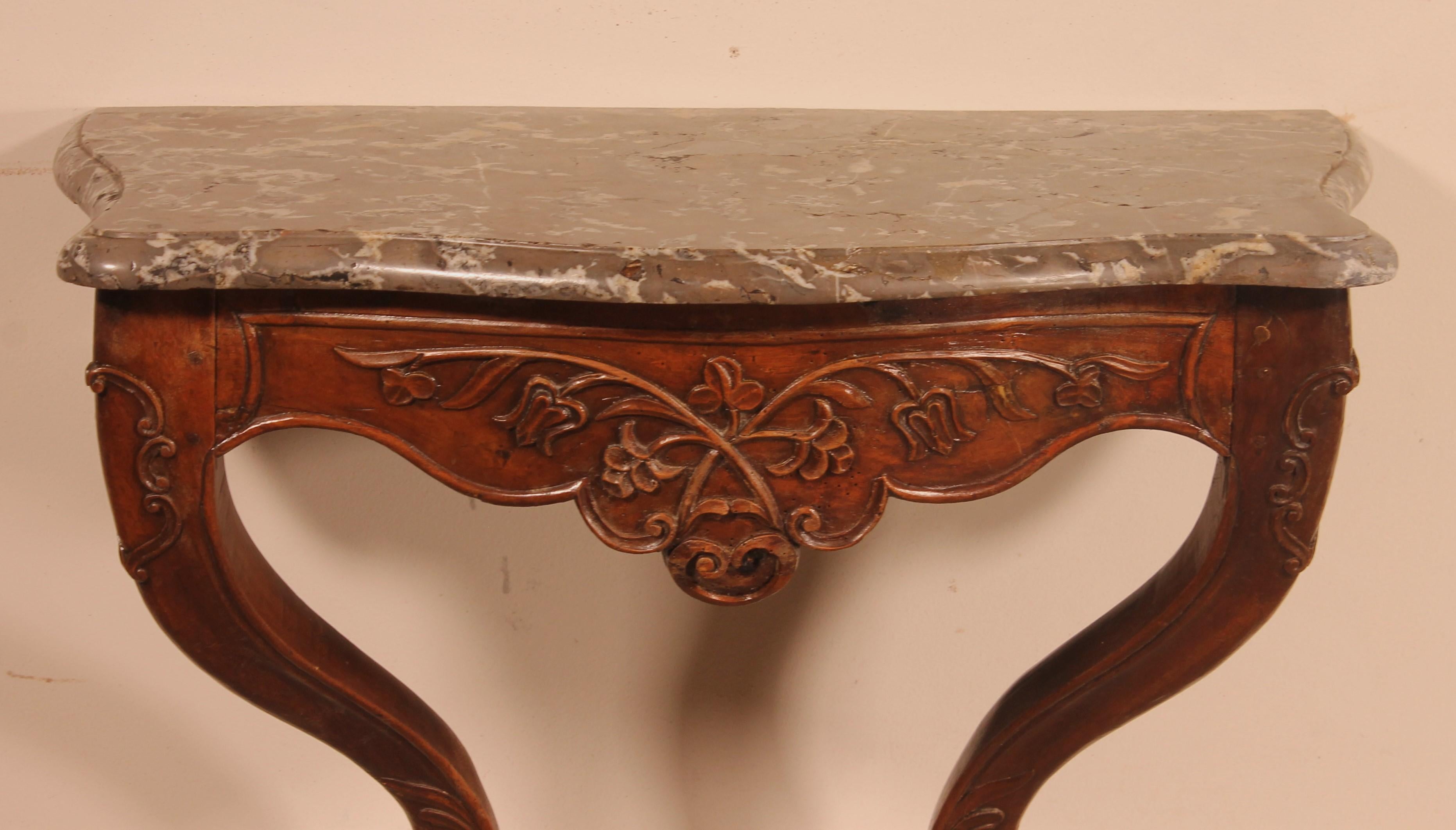 Lovely french walnut console from the 18th century Louis XV style from Lyon

Very beautiful molded and carved walnut console topped with gray marble

Very beautiful marble which is its original corbin beak marble

Very beautiful patina and in