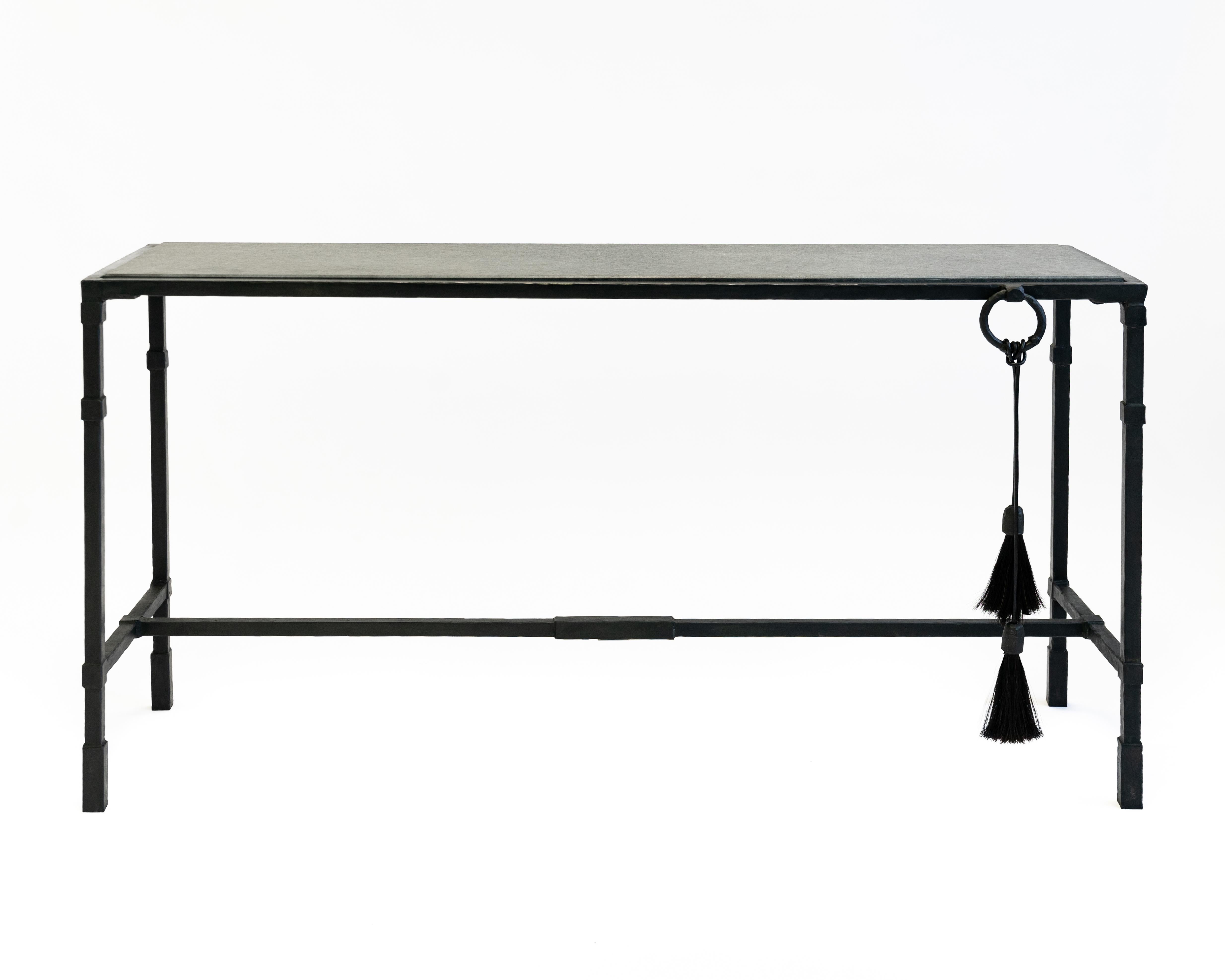 Console No. 3 by JM Szymanski
Materials: Blackened steel and waxed finish
Dimensions: 48” L x 18” W x 33” H 

A beautiful piece of absolute black granite placed into a hand-carved blacked steel frame with a horsehair accent.

Jake Szymanski lives