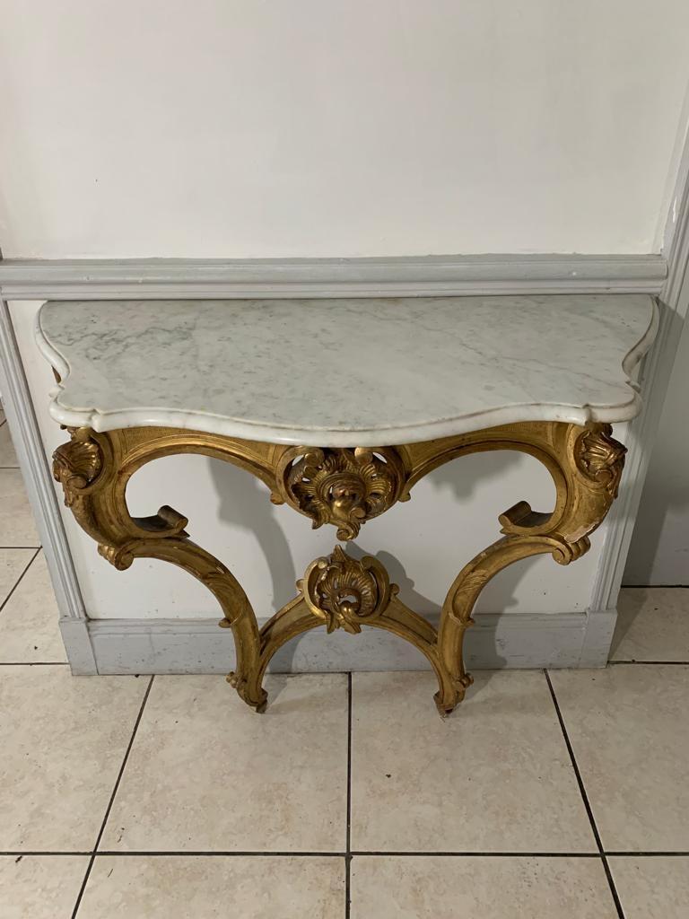 Magnificent console of Louis XV style from the Napoleon III period. 
Composed of many golden volutes, this console reminds us of the finesse and delicacy of this style. The feet are decorated with acanthus leaves and shells. 
Fine and elegant,