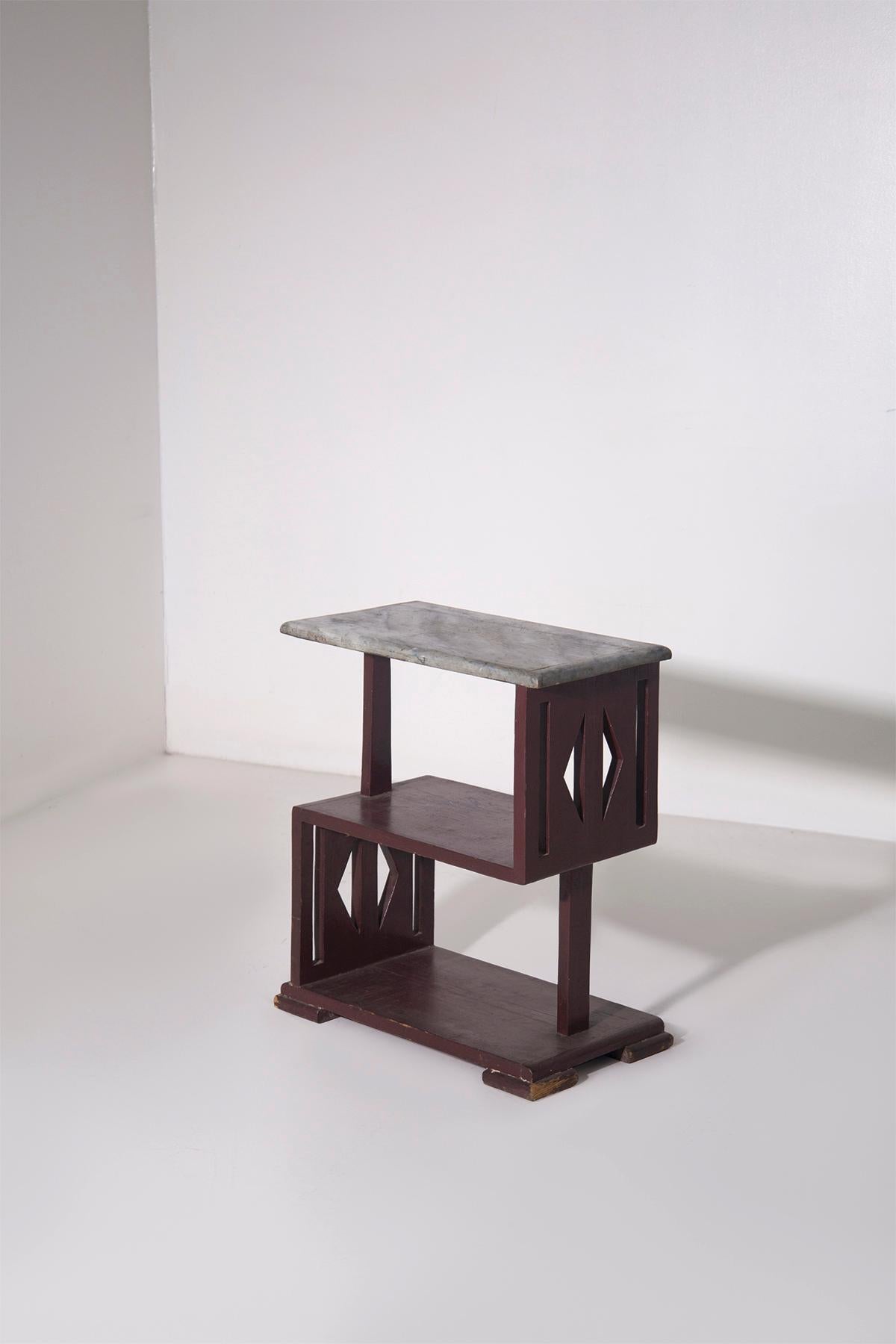 
This exquisite small table or console dates back to the Italian Futurist period of the 1920s, embodying the bold geometric aesthetics characteristic of the movement. A rare and sophisticated piece, this table showcases sharp lines, sculptural