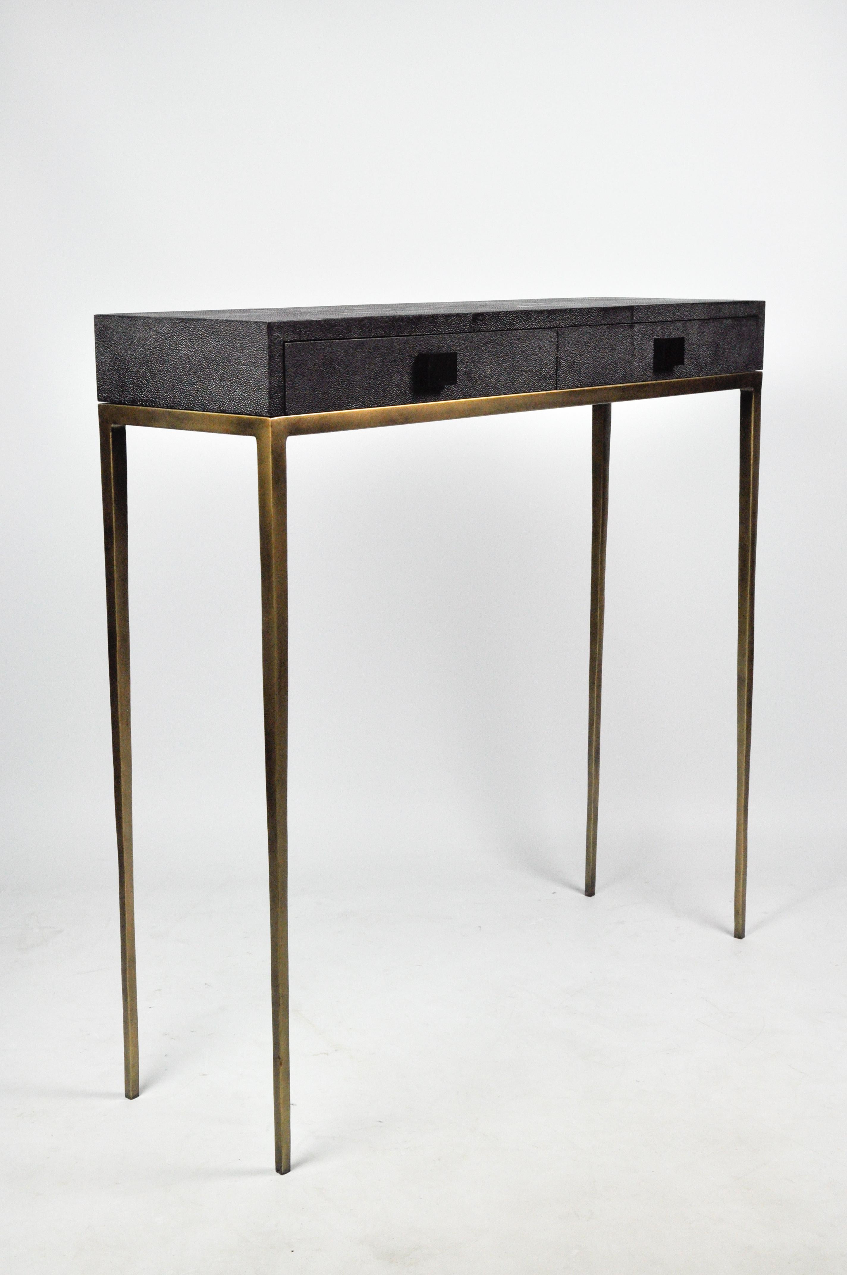 The console table is made of shagreen.
It has two thin drawers and the metal legs have an aged brass patina.
This piece will settle very well in your entrance or your living room.
The style is timeless and chic. No way to get bored of it.
The