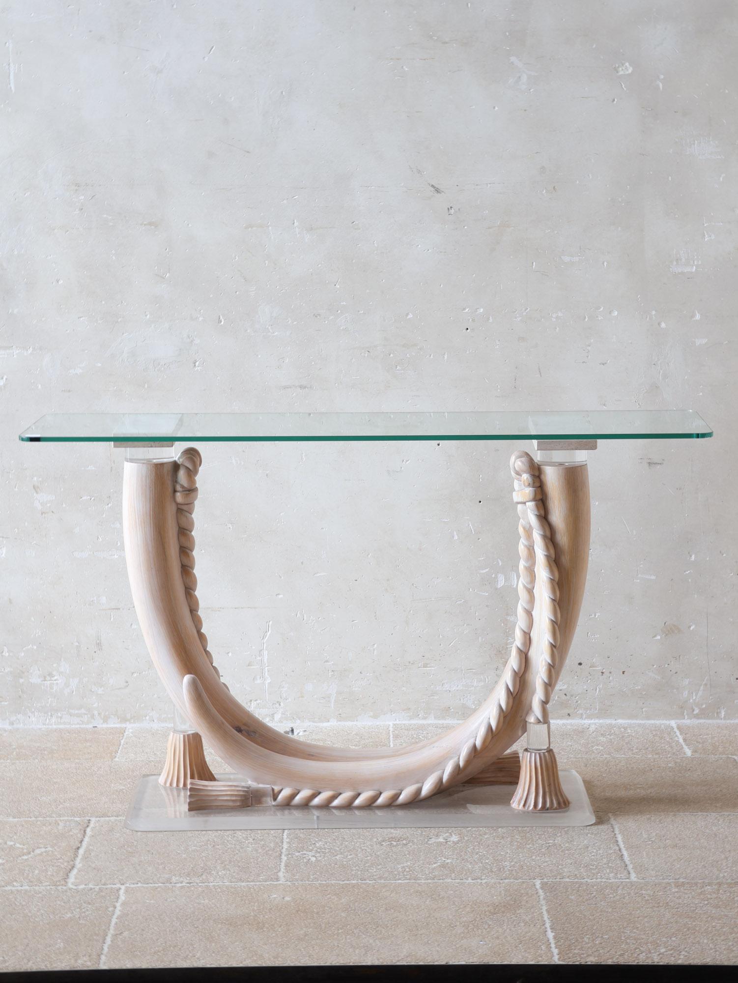 Console table attributed to Sergio Longoni, ca. 1980, Italy. This Italian designer table has a glass top (1 cm thick) and a perlucite base in the shape of tusks, wrapped with cord. The base is placed on a lucite foot.

h 73.5 x w 126 x d 34 cm