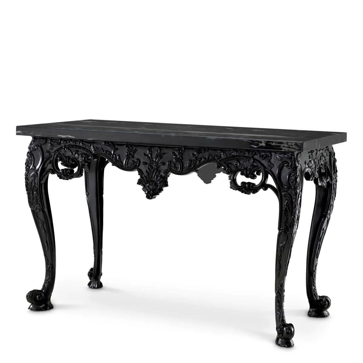 This Console Table is a statement furniture piece that merges 18th-century craftsmanship with modern sophistication. Designed as an elegant focal point, this black marble console table combines a sculptural wooden base with a richly veined marble
