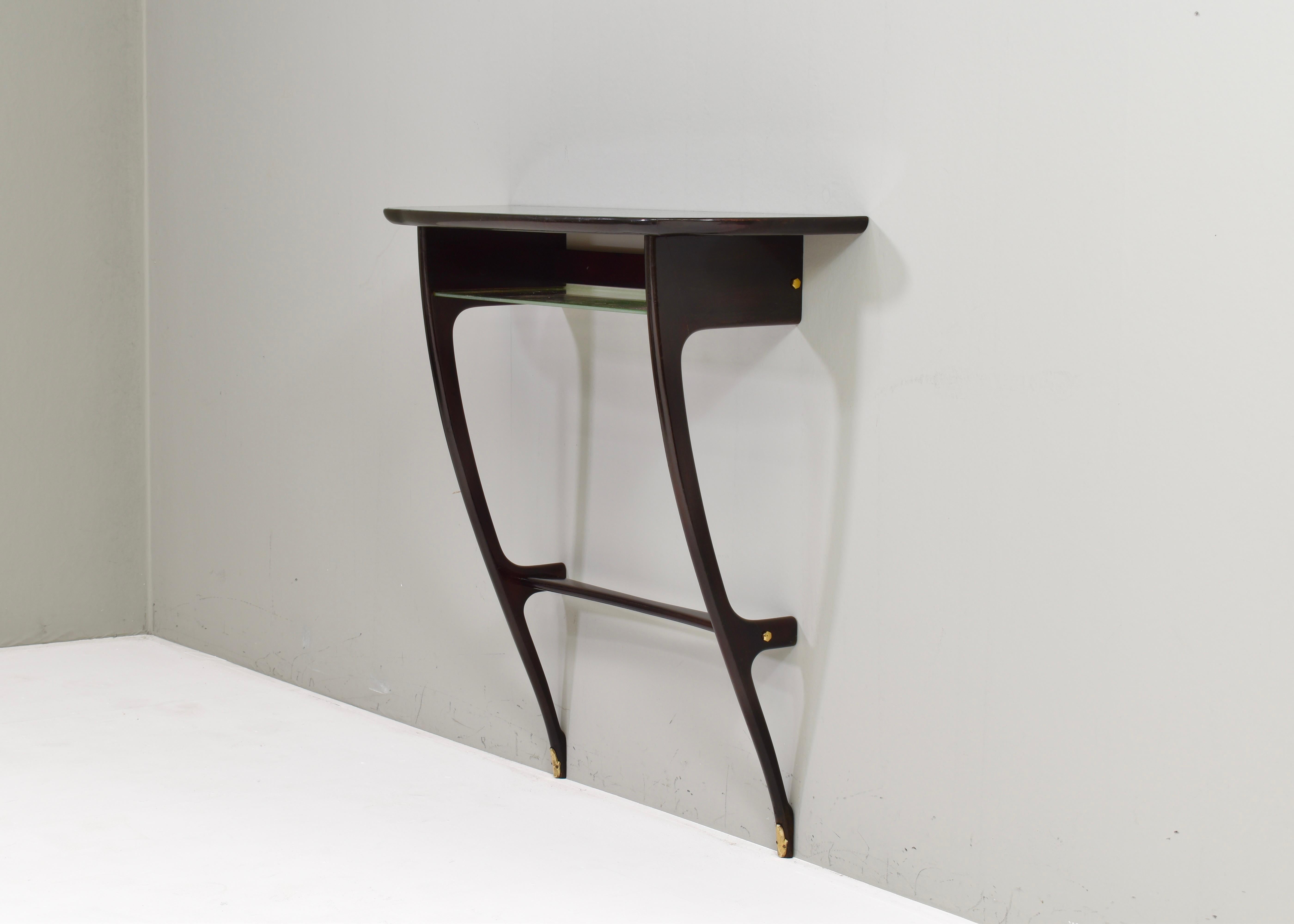 Console Table by or in the style of Ico Parisi in Green glass, Brass and Ebonized wood – 1950s, Italy.
The wood is a very dark brown cherry black colour. 

The table is attached to the wall by two screws in the wood bar beneath the top (simple and