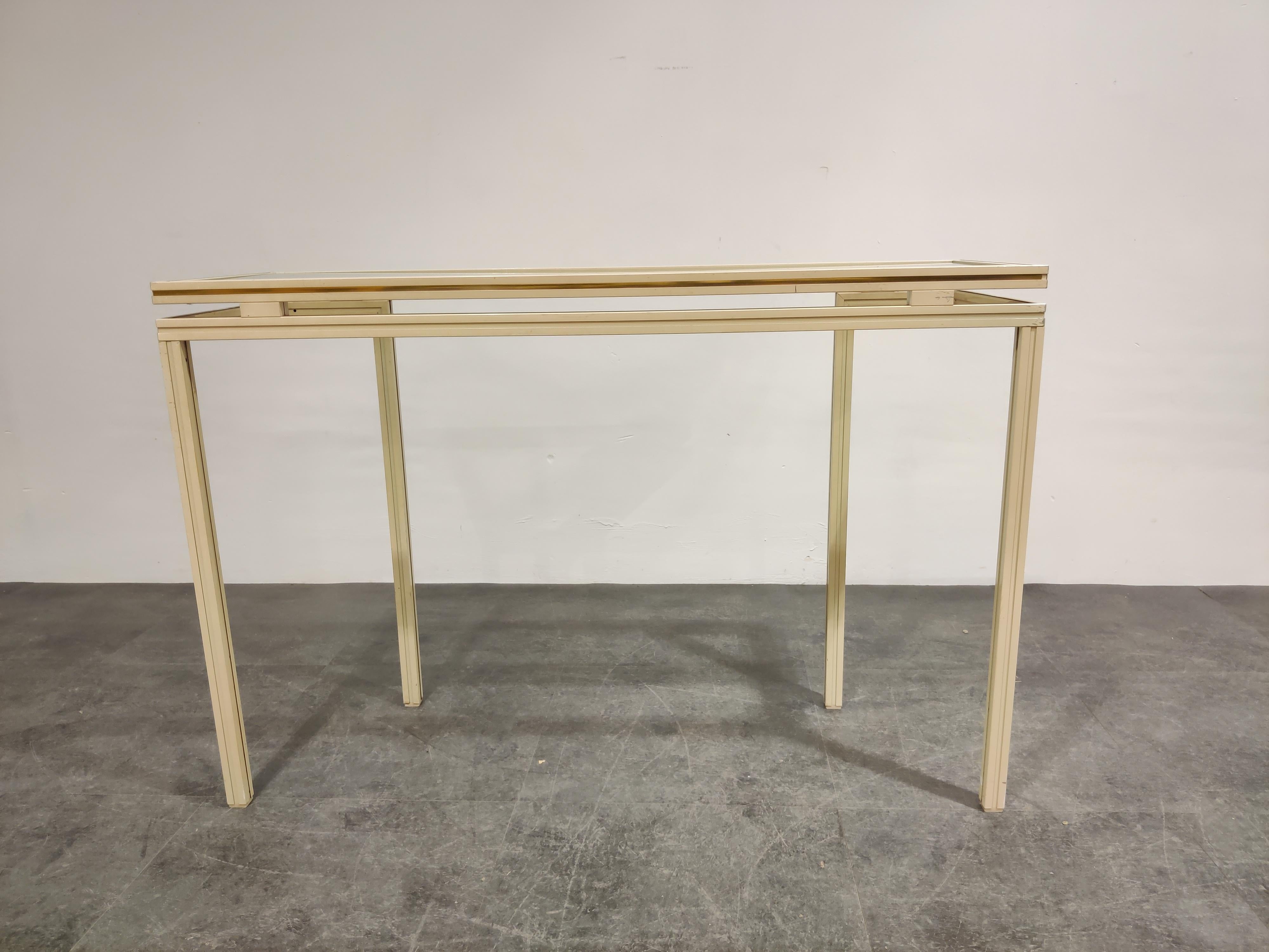 Vintage beige lacquered console table by Pierre Vandel.

This geometrical design console table has a clear glass top.

Hollywood regency style.

Perfect condition.

1980s, France

Dimensions:
Height 74cm/29.13