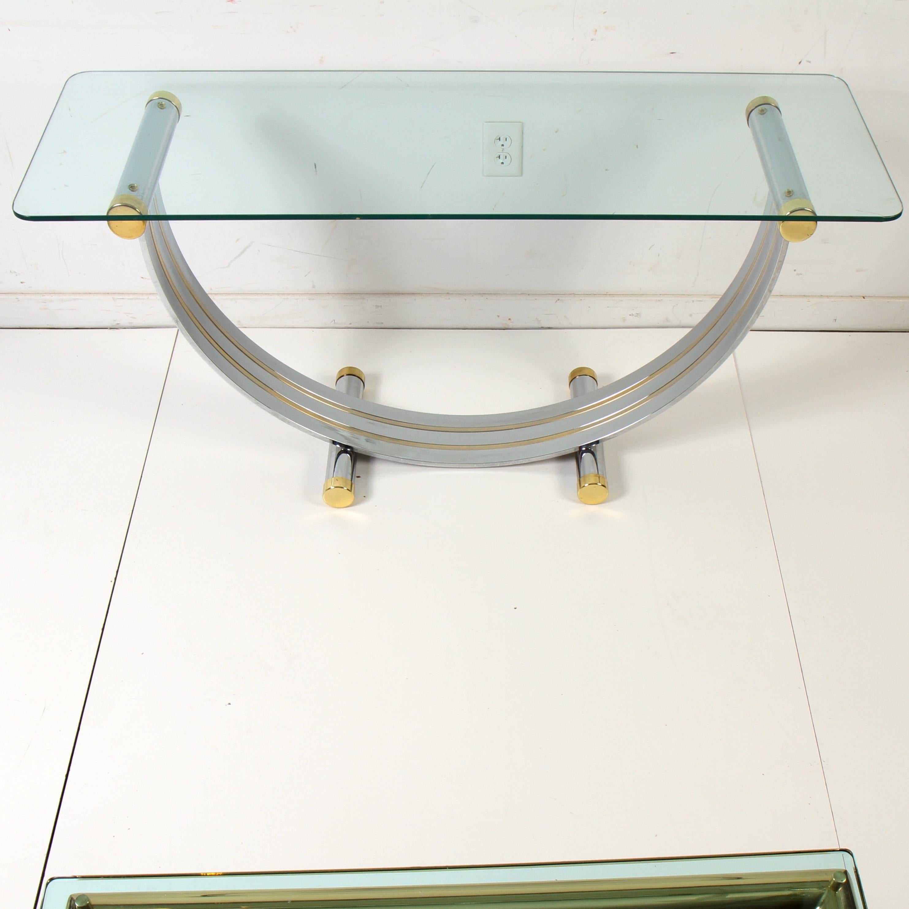 Chrome and glass console table with brass inserts and end caps by Italian designer Romeo Rega. In very clean condition with no pitttinr signs of wear to either the chrome or brass. Glass is pristine also.

Rega was born in 1904 and is best known
