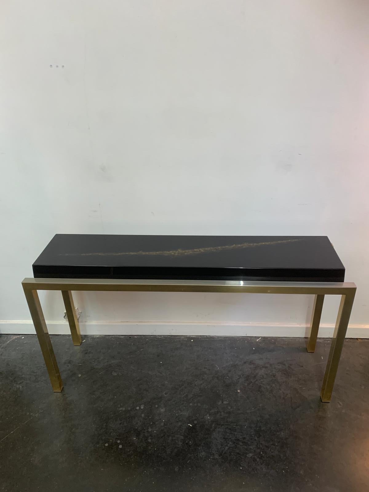 Console table in lacquered wood with nice design included and brass