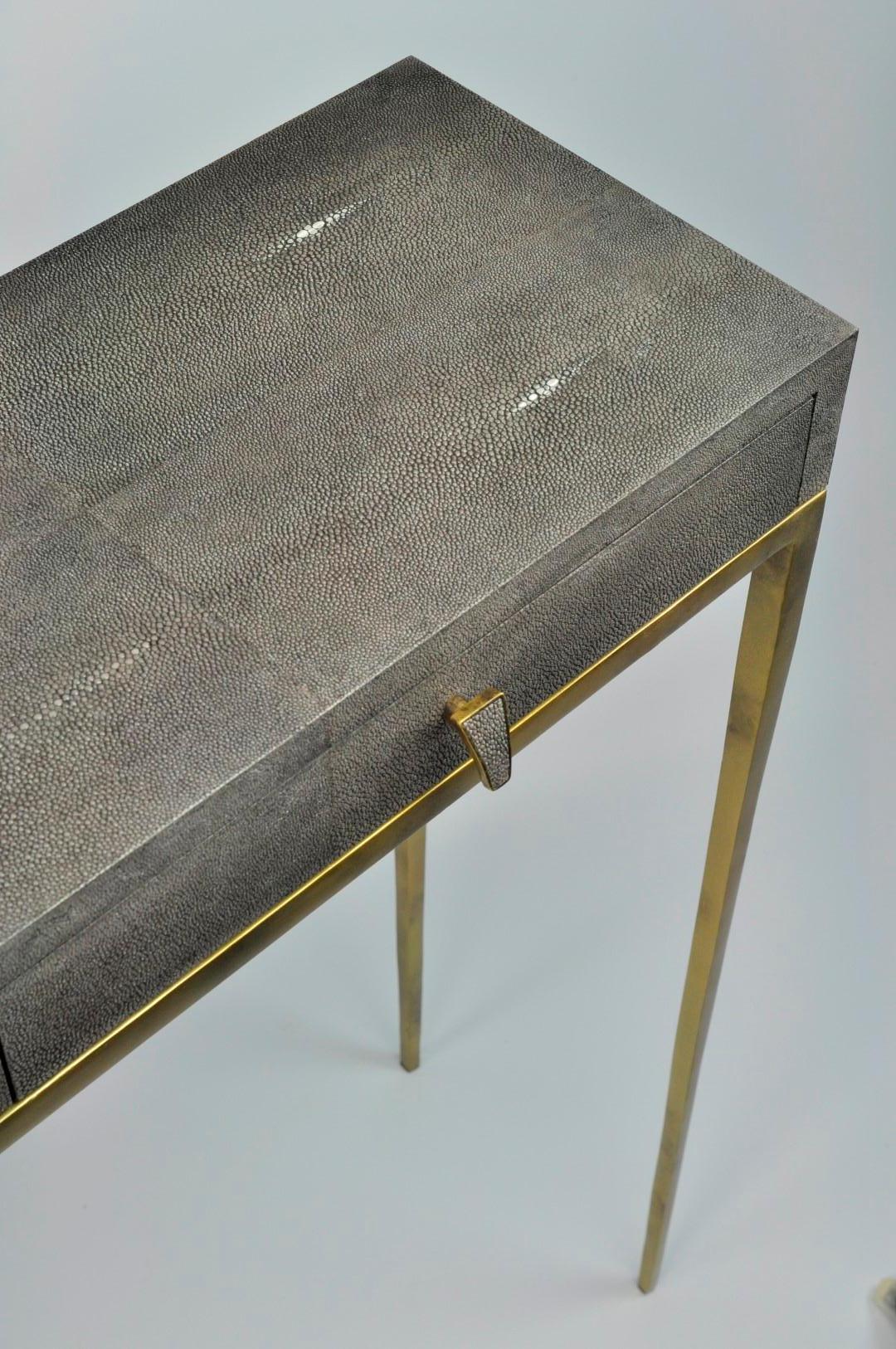 The console table CS419 is made of shagreen.
It has two thin drawers and the legs have an old brass patina.
This piece will settle very well in your entrance or your living room.
The style is timeless and chic. No way to get bored of it.
The