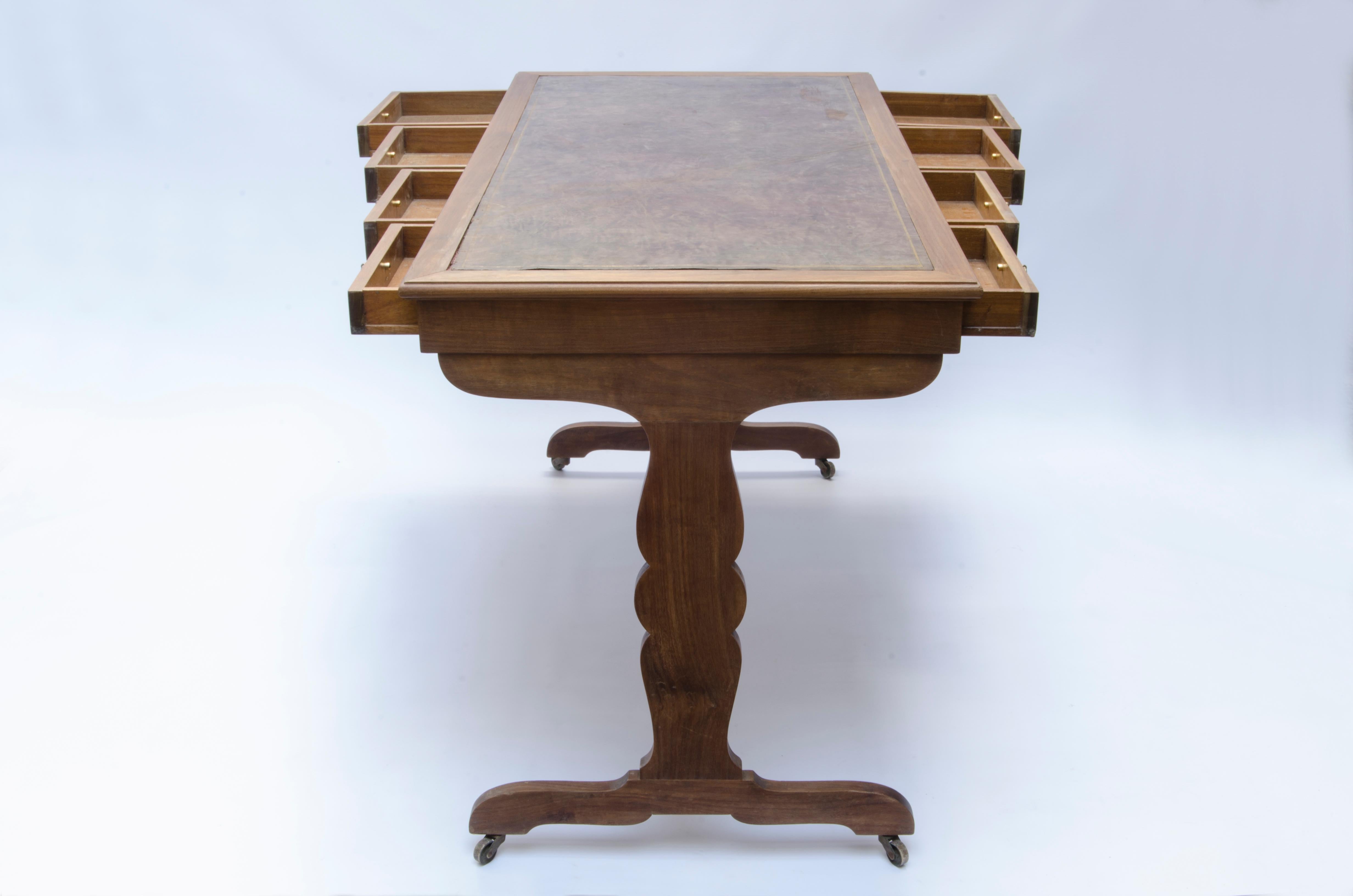 Writing desk made of oak with leather covered top and golden vignette. The table has 8 drawers, 4 on each side.
Design by Jean-Michel Frank(1895-1941).

France, CIRCA 1930.