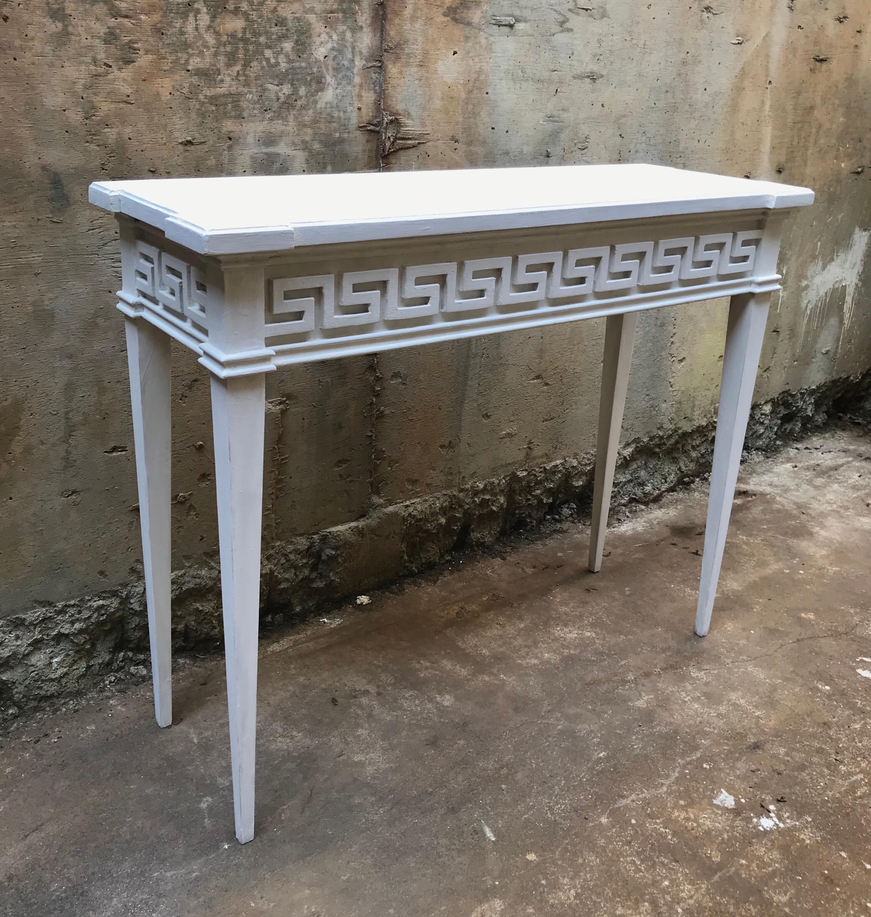 A smart looking console table having neoclassical bones and a fetching Greek key paneled and gilt detail. Each table is bench made by hand in Virginia and constructed with pride. The custom and modular table can be ordered to your exact size and