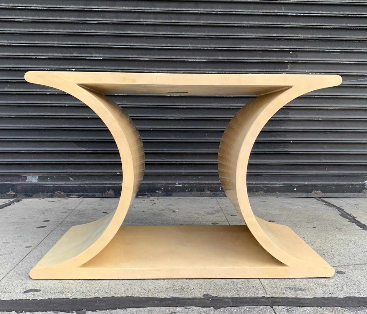 Beautiful console table designed by Sally Sirkin Lewis and manufactured by J. Robert Scott.

The table is covered in Goatskin parchment and has beautiful lines.

The table retains the original finish and original label.

Measurements:
36