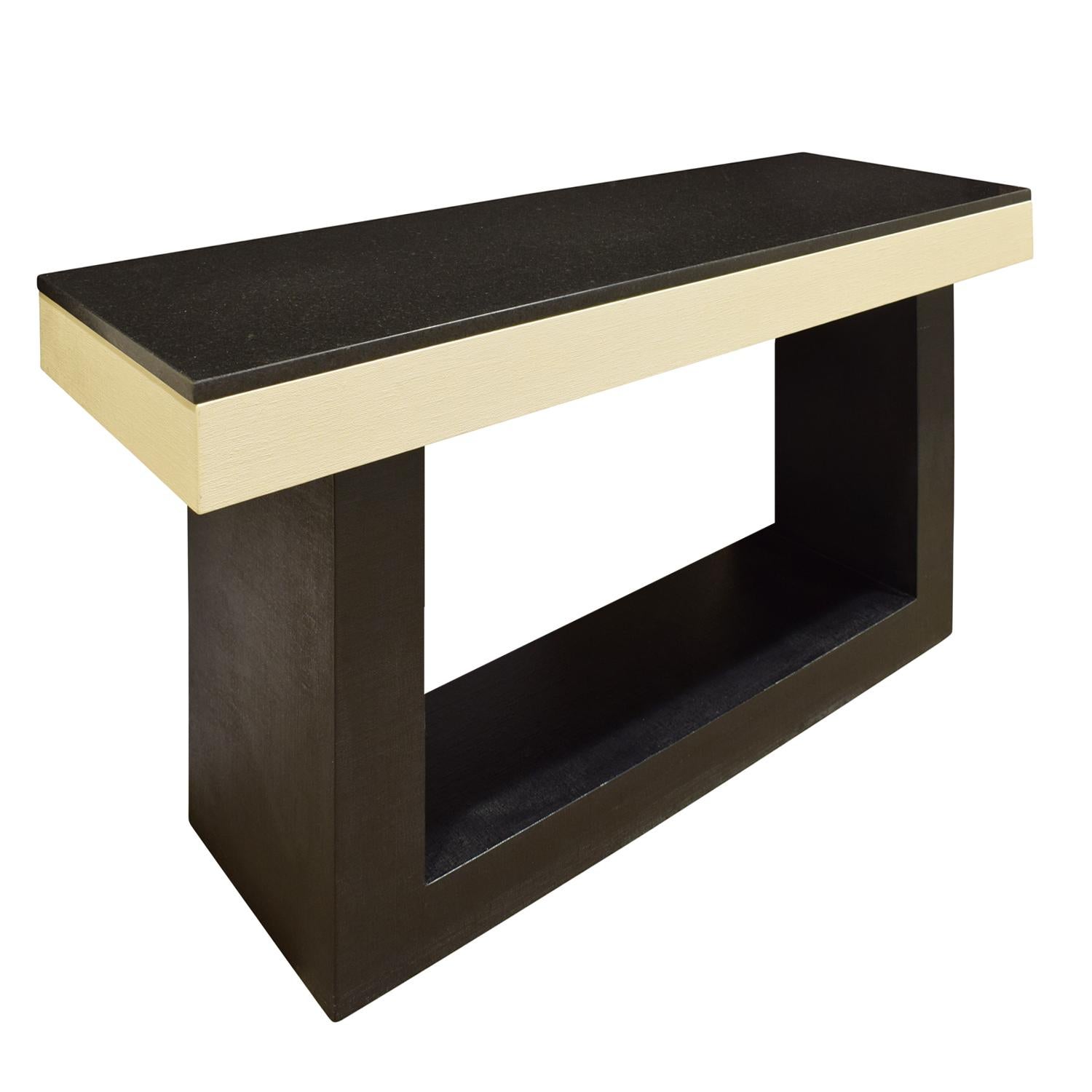Clean line console table in black and ivory lacquered linen with black granite top, custom design, American, 1970s. This piece is beautifully made and luxurious.