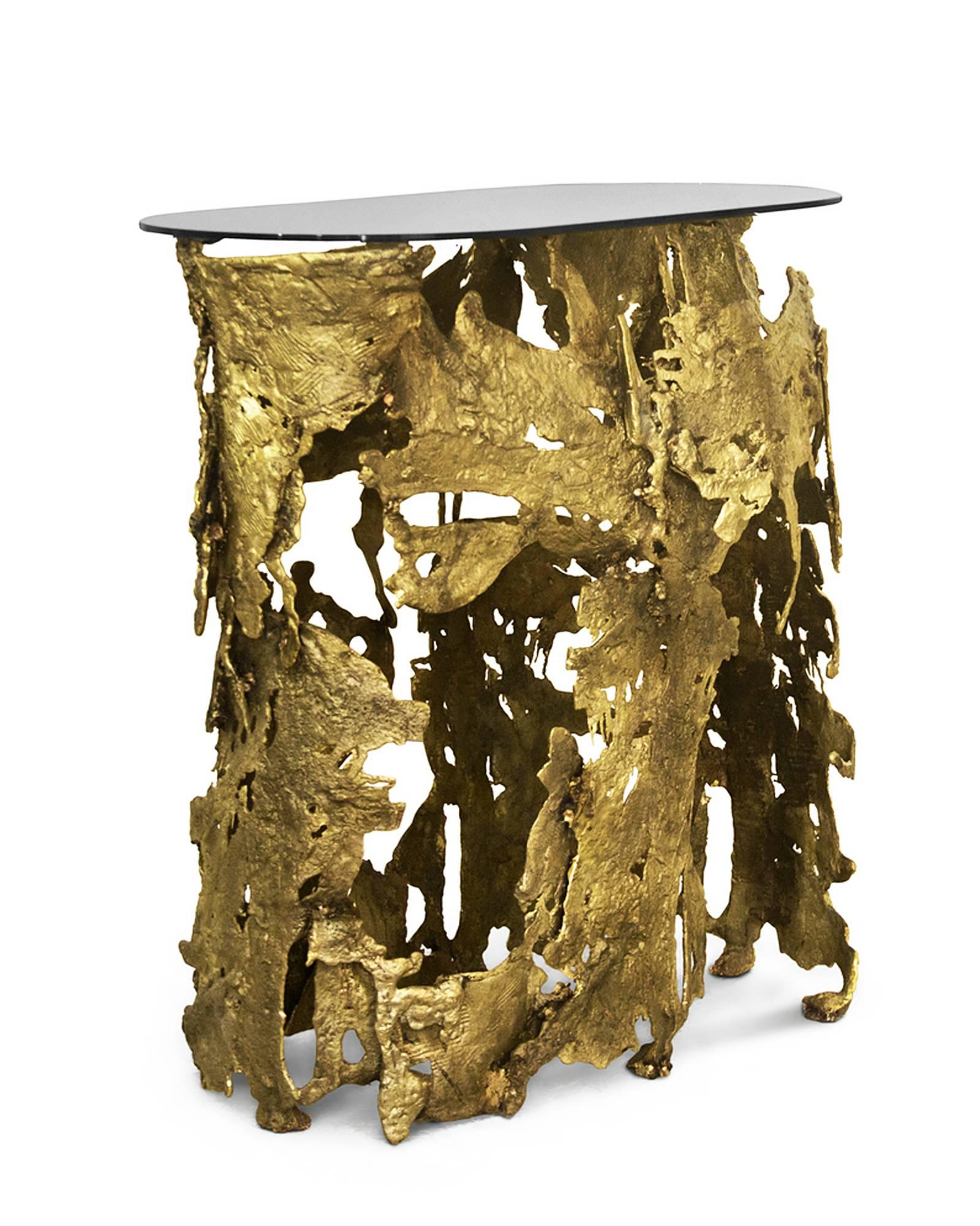 Lava console table made with
Casted brass base.
With oval tabletop in glass bronze finish.