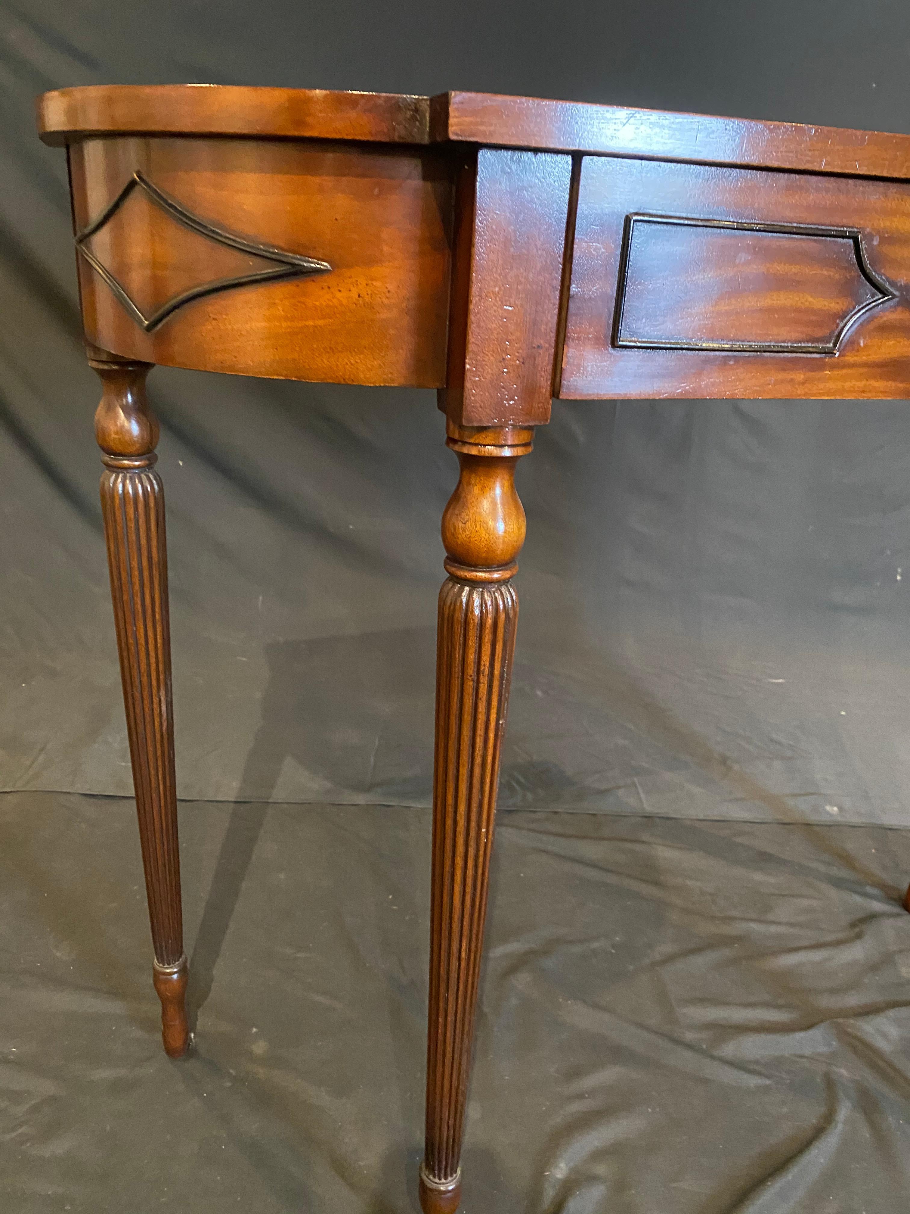 A very finely detailed mahogany console table by Arthur Brett, in mahogany with relief detail. Elegant curved lines and reeded legs add to the elegance of this excellently crafted piece for the discerning individual of Georgian style mahogany