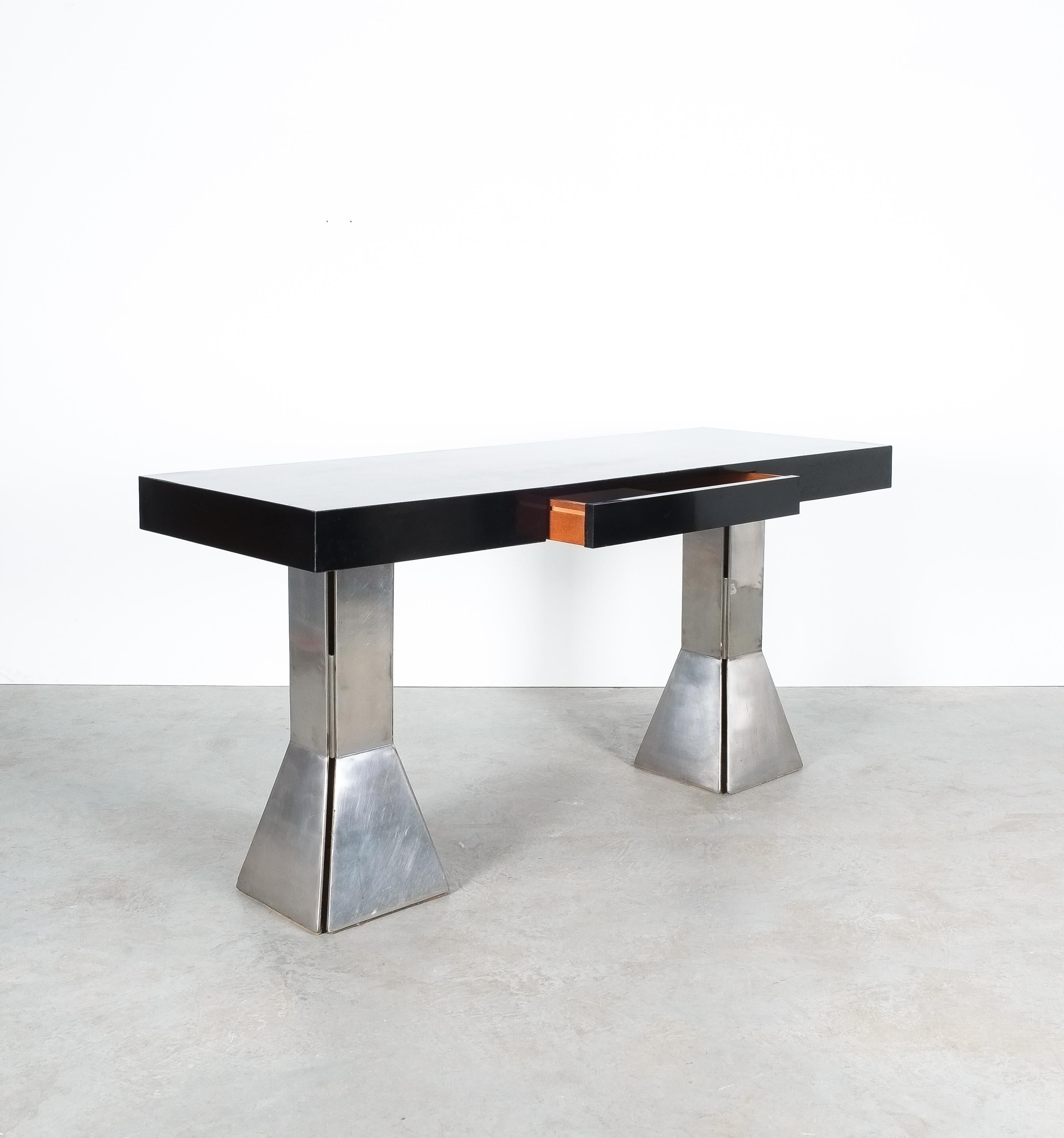 Unique black formica bespoke writing desk with heavy steel feet and drawer, Italy, circa 1970-1980.

Perfectly sized desk or console table with a large drawer (21