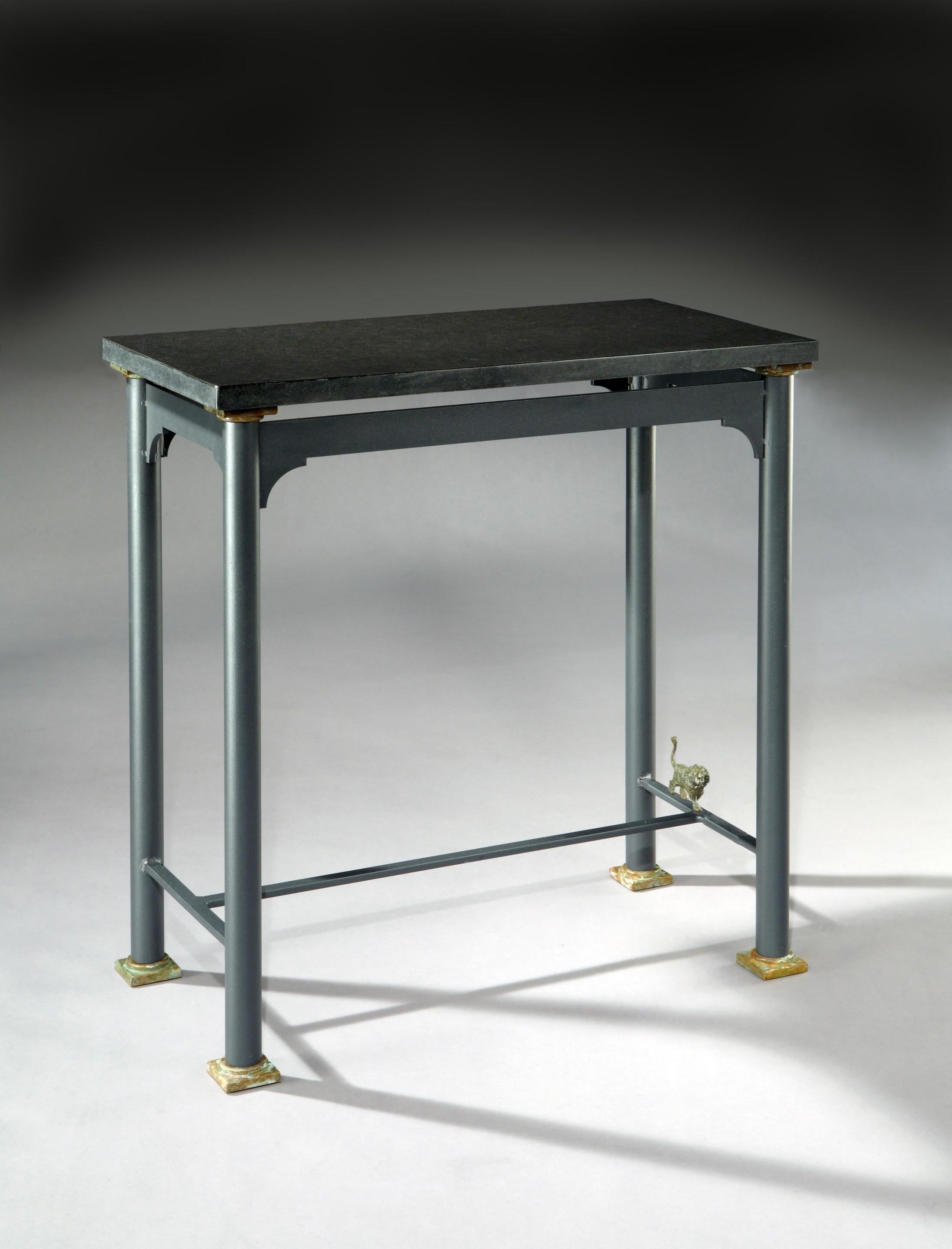 A painted steel, console table with a shaped frieze inspired by a 17th century, Flemish cabinet. Standing on turned legs joined by an ‘H’ stretcher with a bronze, sculpted lion on one side stretcher.
 
Can be supplied with either a glass, slate or