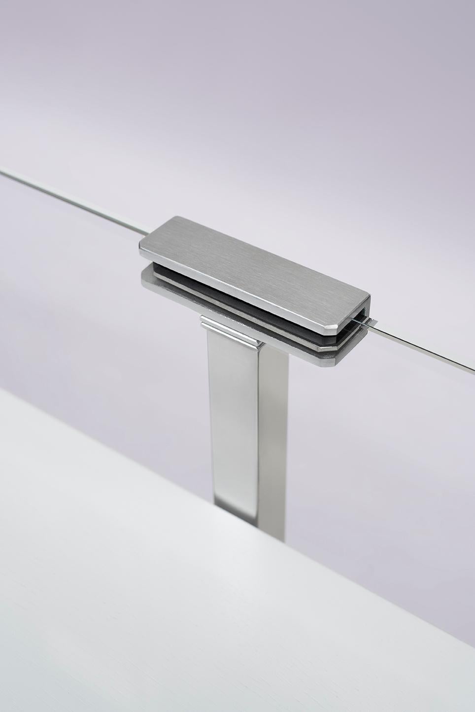 This late 20th century Bauhaus style 'Tron' T54L console table was designed by Peter Ghyczy in 1997 and hand-made in the GHYCZY atelier in the South of the Netherlands. The 'Tron' T54L console table features two mirrored and polished stainless-steel