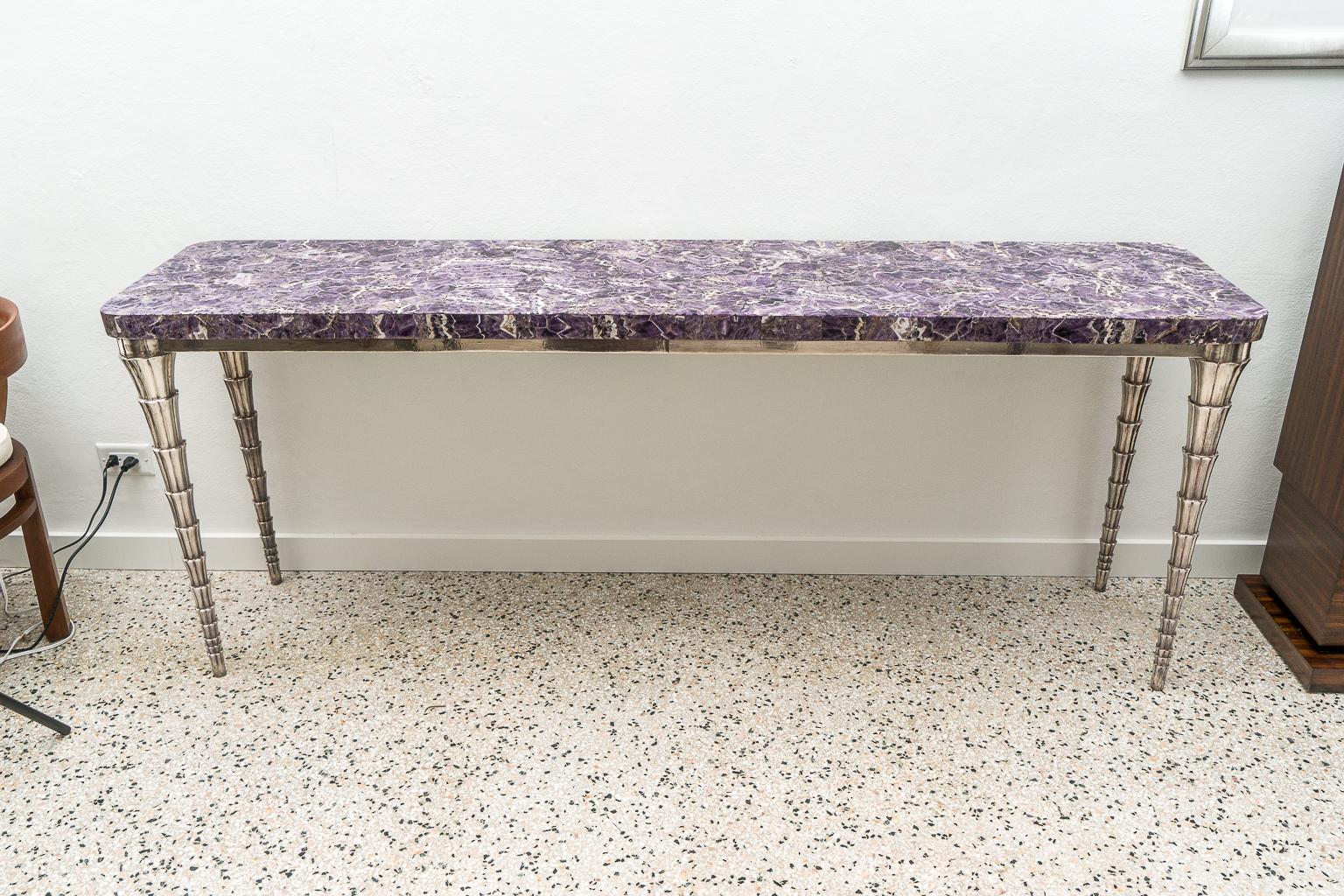 Cornet table designed by Paul Mathieu for the Stephanie Odegard Co. Ltd.

Hand carved teak console table is clad in pure silver and adorned with a purple and white accented abstract mosaic top. A modern interpretation of the Anglo-Indian style,