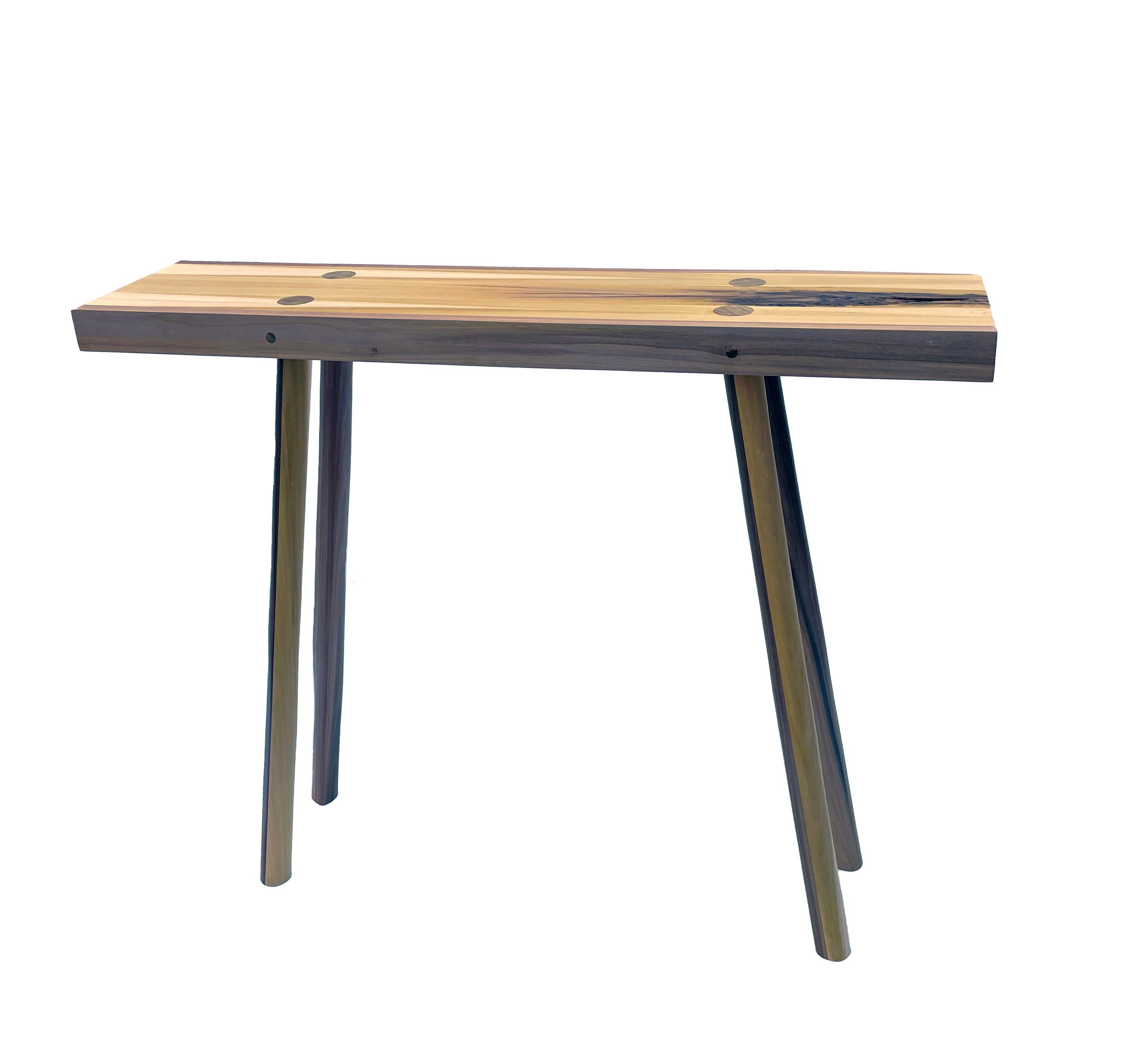 The simplicity of this console table allows for the natural beauty of the wood to come through. Rainbow poplar has subtle shades of green, purple, grey and beige made possible by different minerals in the soils where the tree was grown. These subtle